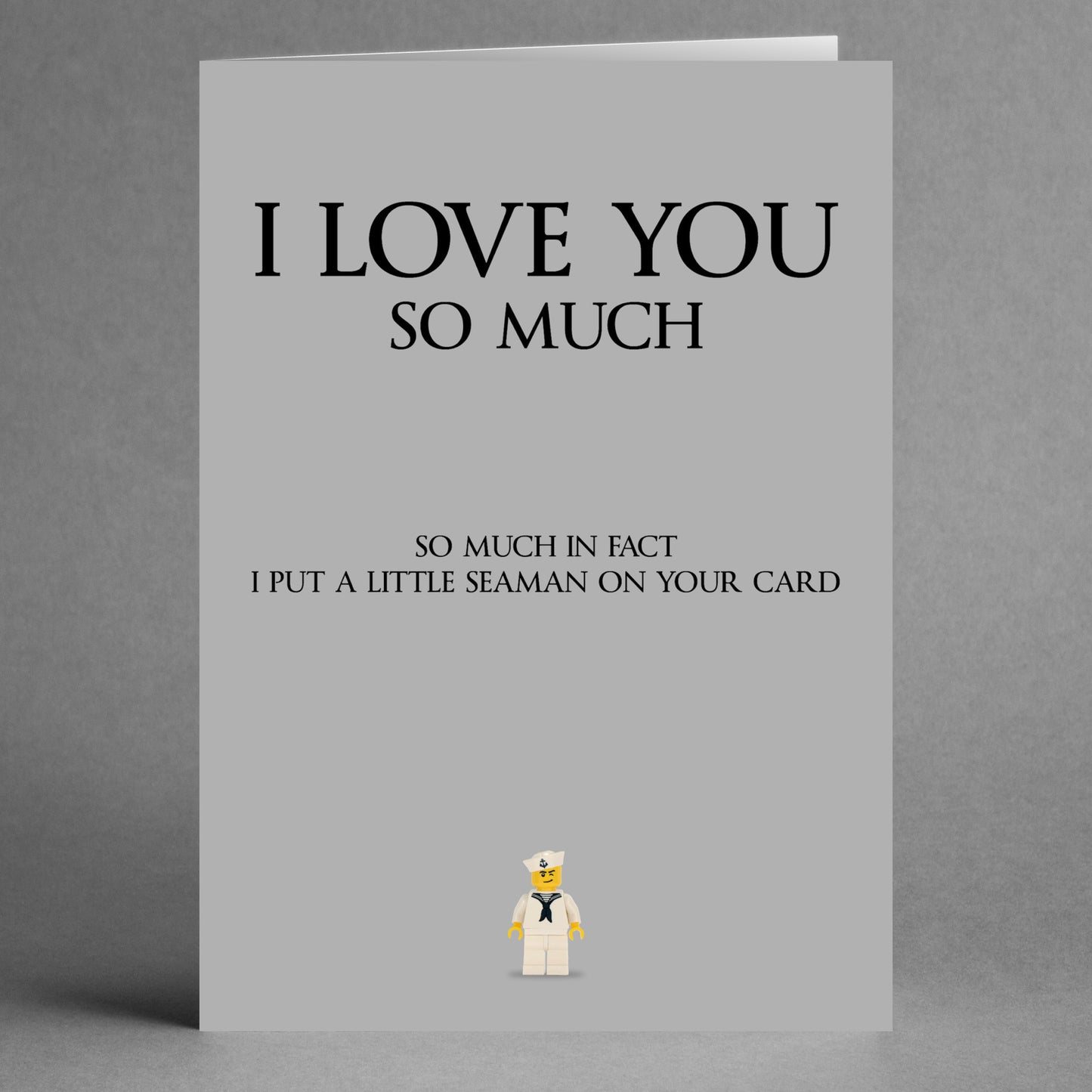 Introducing the Seaman Rude Valentine's Card by Twisted Gifts: This cheeky grey card humorously declares "I love you so much," with the playful addition, "I put a little seaman on your card." Featuring a small sailor LEGO figure at the bottom, it's perfect for anyone who enjoys a bit of nautical humor on Valentine's Day.