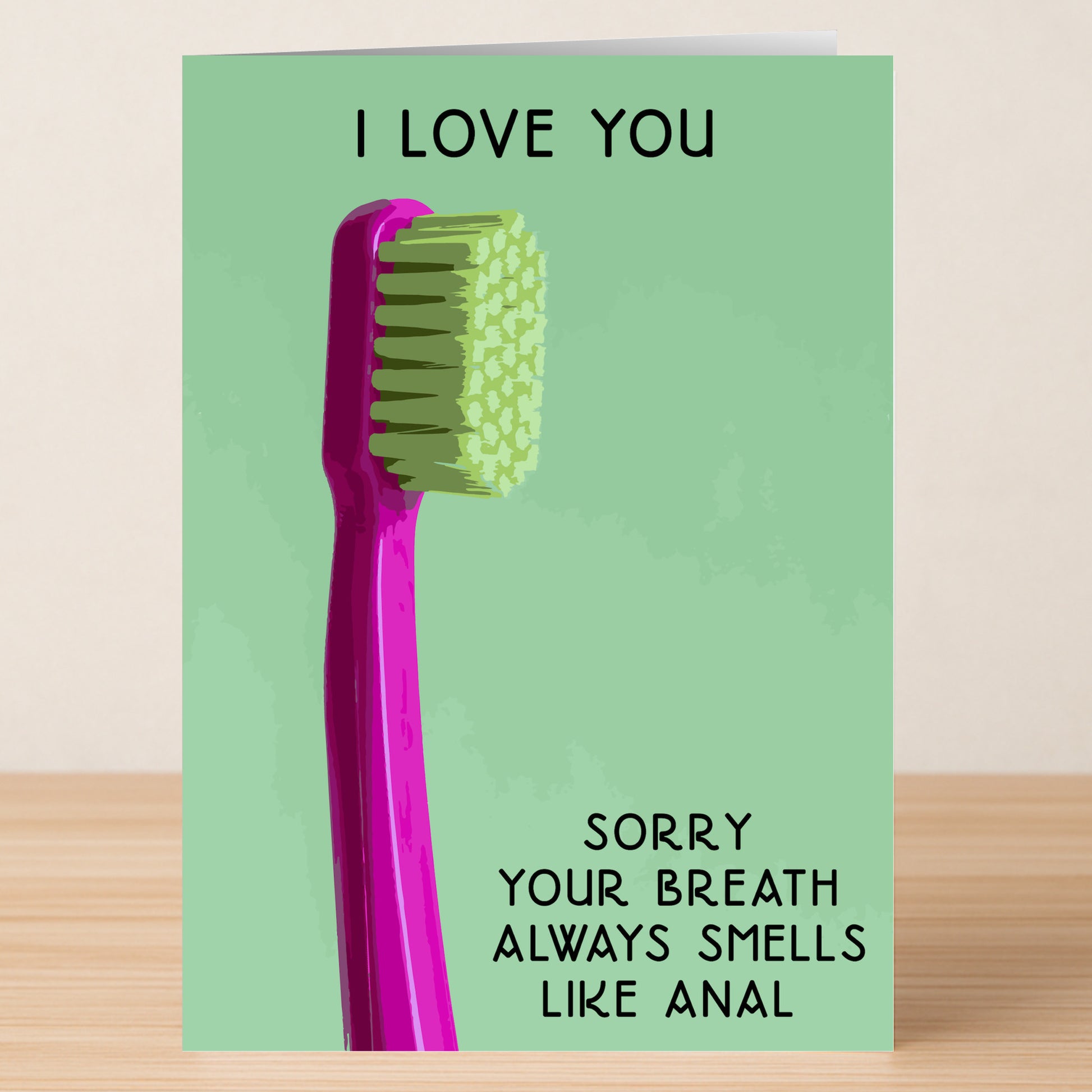 The Breath Twisted Valentine's Card by Twisted Gifts features a pink toothbrush on green and the cheeky message: "I LOVE YOU. Sorry your breath always smells like anal.