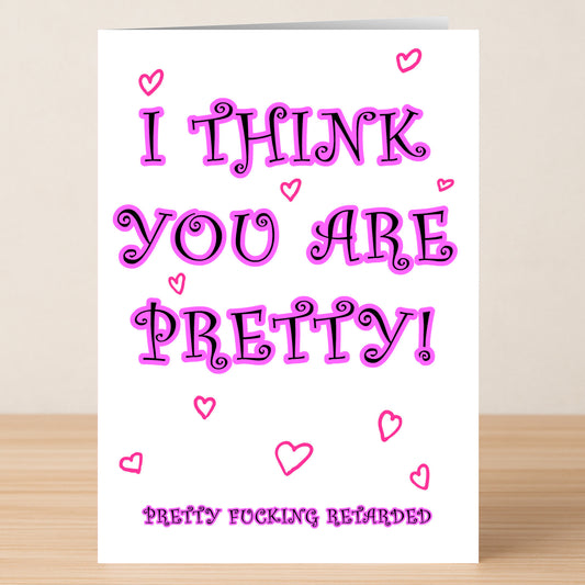 The Retard Insulting Valentine's Card by Twisted Gifts features bold text saying "I THINK YOU ARE PRETTY!" and "PRETTY FUCKING RETARDED," with pink hearts—an edgy Valentine’s card for someone with a cheeky sense of humor.