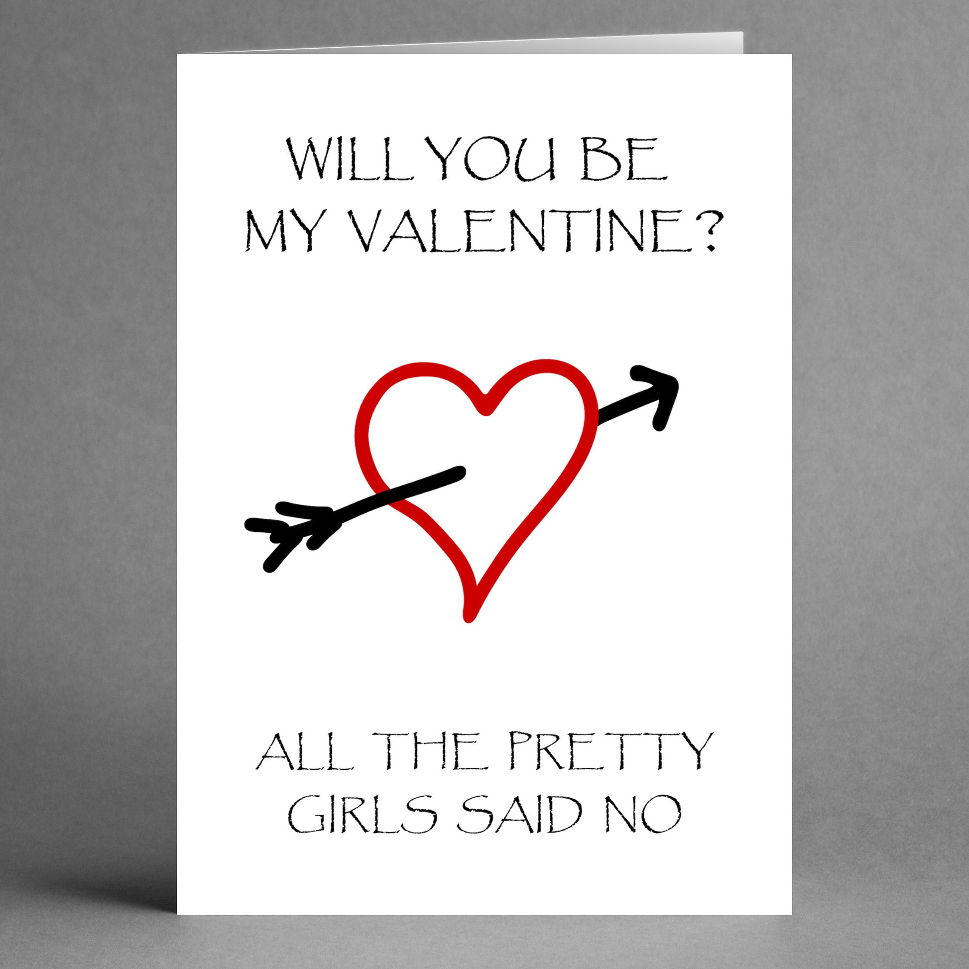 Twisted Gifts' Pretty Insulting Valentine's Card features a red heart pierced by an arrow with the text, "Will you be my Valentine? All the pretty girls said no." It's a playful and quirky card for those who love a unique and fun way to be charmingly candid.