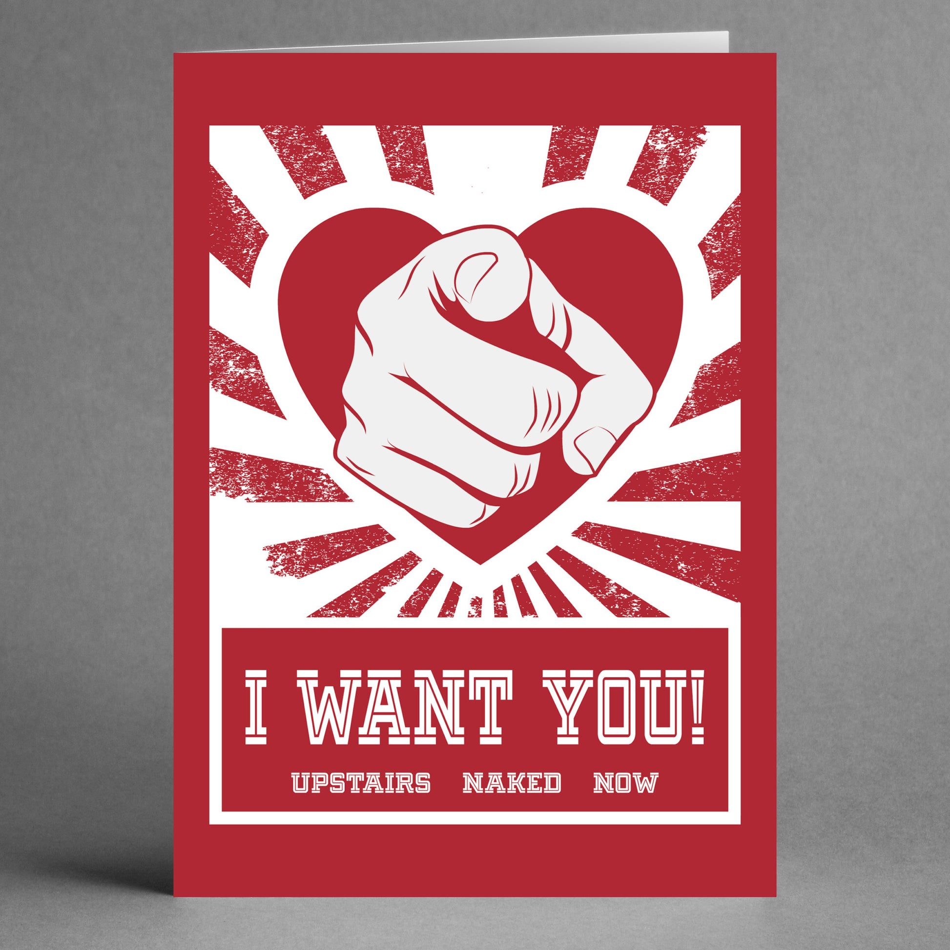 The Naked Now Rude Valentine's Card by Twisted Gifts features a playful design with a red heart and pointing finger, along with the cheeky message: "I WANT YOU! UPSTAIRS NAKED NOW." Ideal for those seeking a humorous and bold Valentine's card.