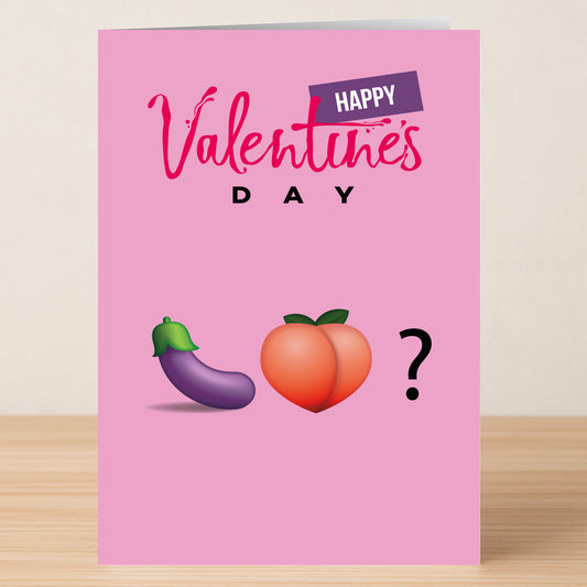 The Emoji Love Funny Valentine's Card by Twisted Gifts is a pink Valentine’s card featuring “Happy Valentine’s Day” and playful eggplant, peach, and question mark emojis in a row for a unique touch.