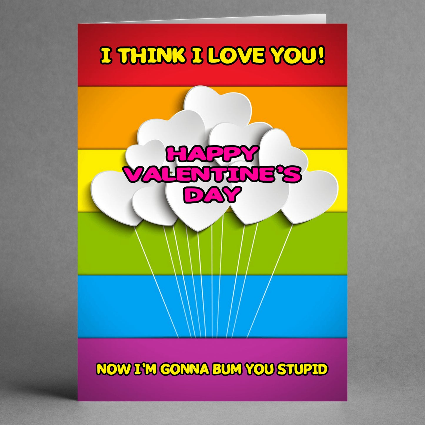 A funny greeting card from Twisted Gifts, named the "Bum You Rude Valentine's Card," showcases heart balloons with the text: "I THINK I LOVE YOU! HAPPY VALENTINE'S DAY, NOW I'M GONNA BUM YOU STUPID.