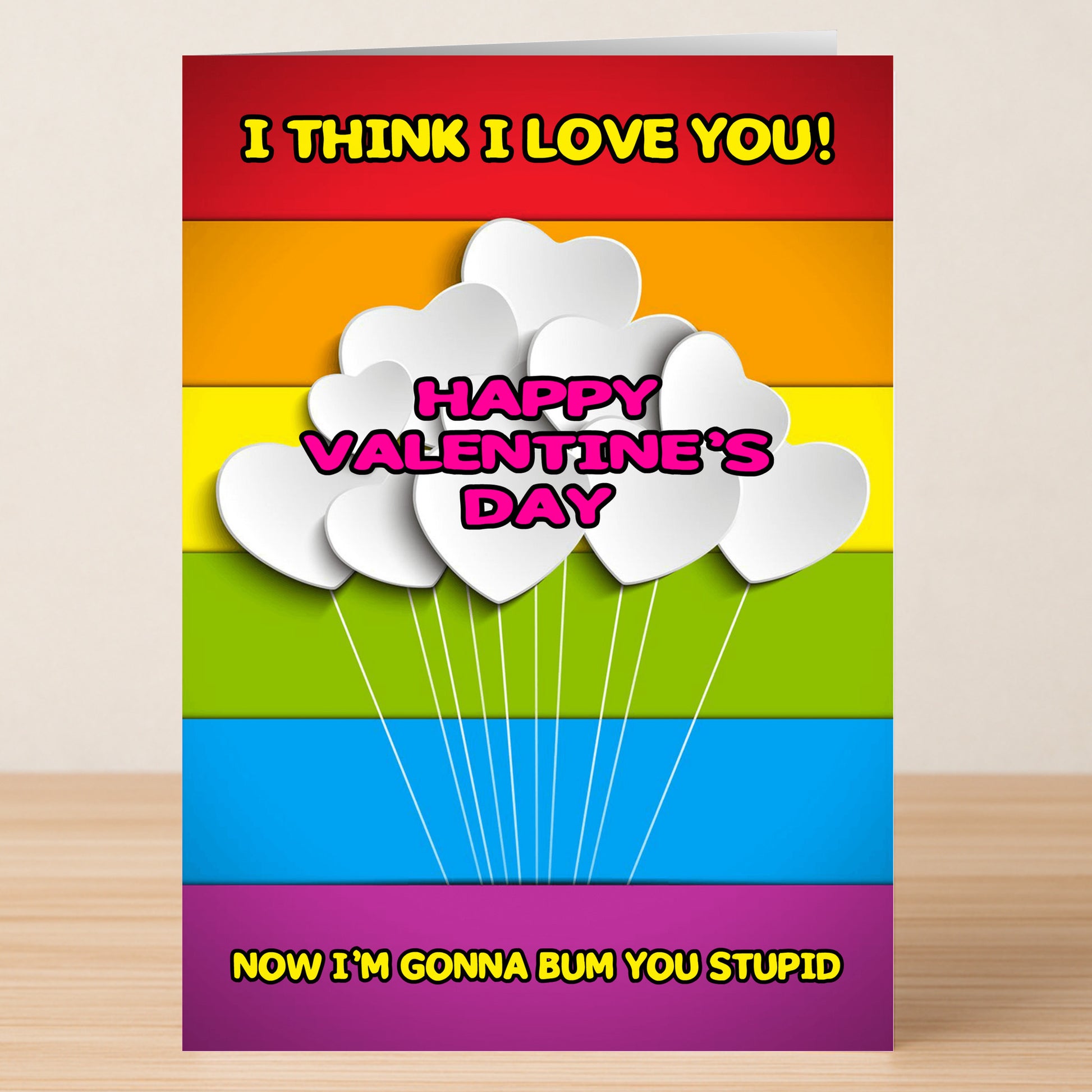 The Bum You Rude Valentine's Card by Twisted Gifts is a humorous card featuring rainbow stripes, white heart-shaped balloons, and cheeky messages—a unique way to celebrate Valentine’s Day.
