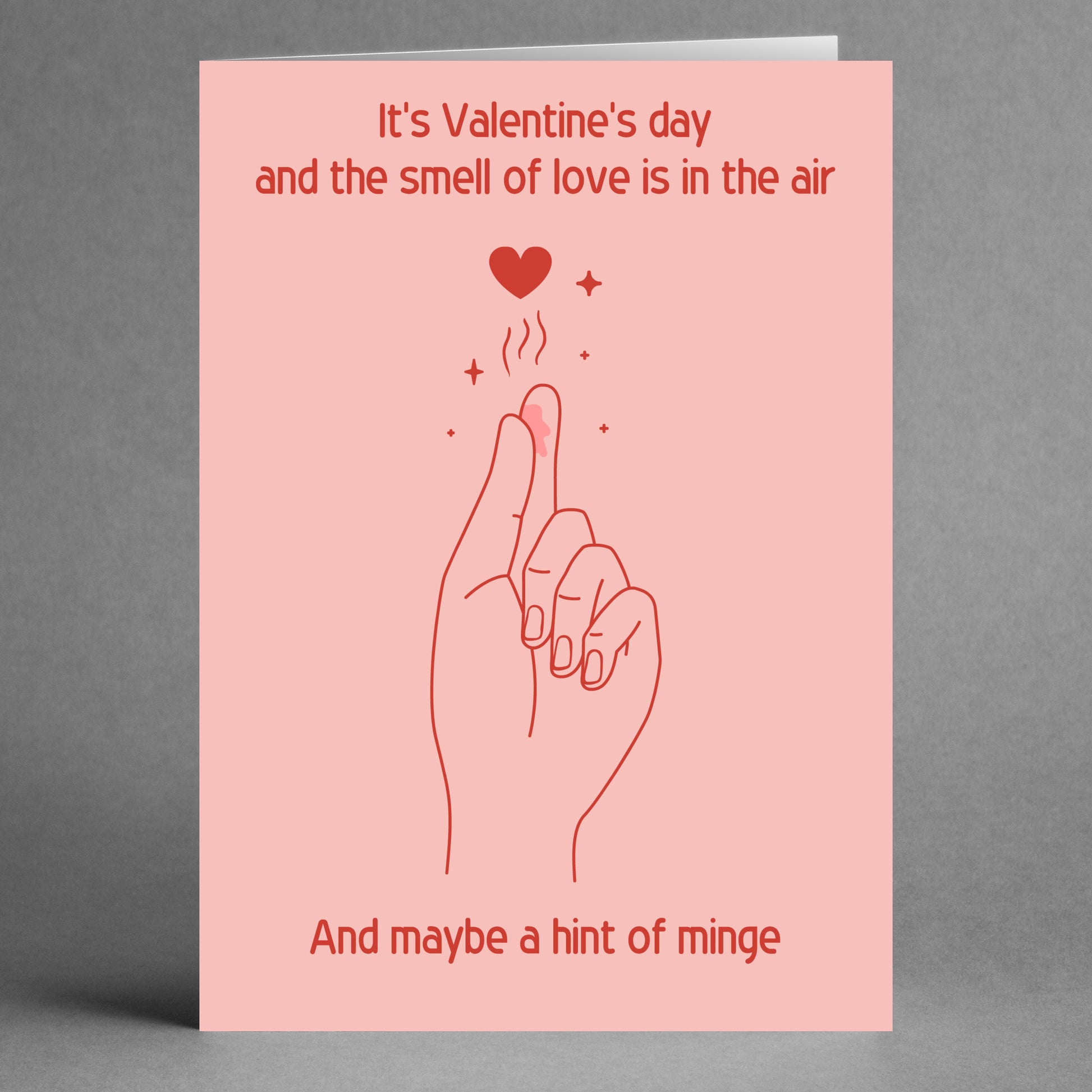 The Love In The Air Rude Valentine's Card by Twisted Gifts showcases a quirky hand and heart illustration, with playful text about love and scent.