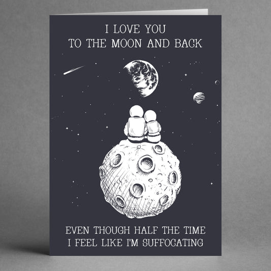 The Moon And Back Funny Greeting Card by Twisted Gifts features a design with two astronauts sitting on the moon, gazing into space. The card includes the humorous text: "I love you to the moon and back, even though half the time I feel like I'm suffocating." It's perfect for a Valentine's Day greeting that combines love and laughter.