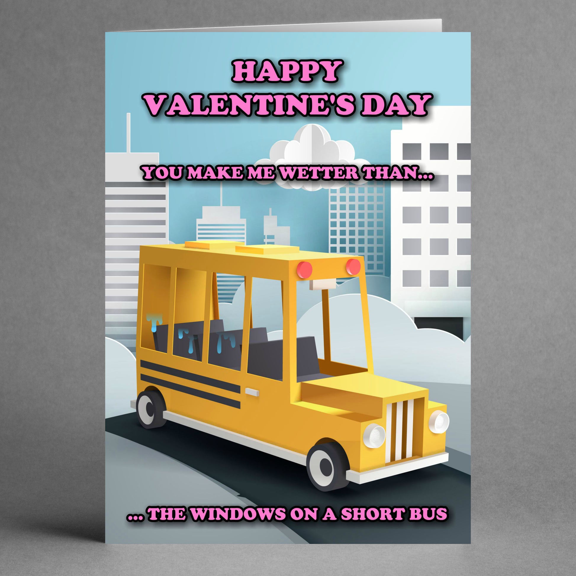 The Short Bus Funny Valentine's Card by Twisted Gifts showcases a cartoon cityscape and school bus. The humorous text includes, "Happy Valentine's Day" and "You make me wetter than... the windows on a short bus," blending humor with quirky language for a playful touch.