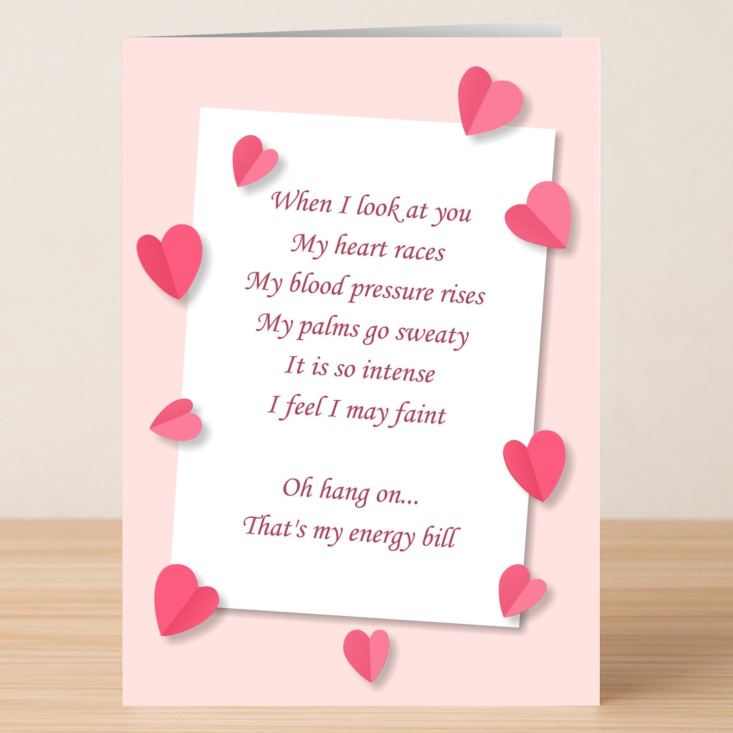 The Energy Bill Funny Valentine's Card by Twisted Gifts features pink hearts and a witty love poem, ending with the punchline that those intense feelings are actually thanks to the energy bill.