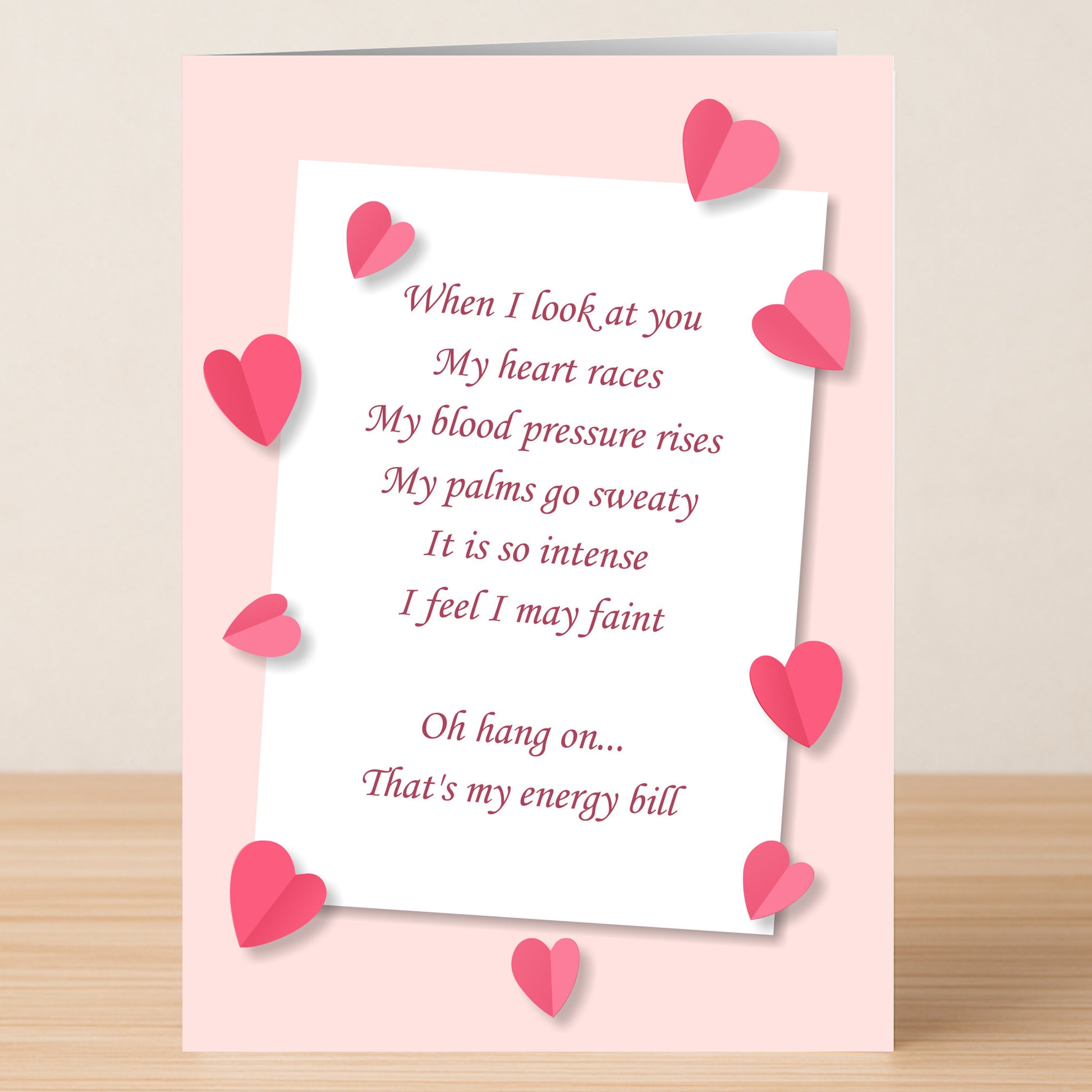 The Energy Bill Funny Valentine's Card by Twisted Gifts features pink hearts and a witty love poem, ending with the punchline that those intense feelings are actually thanks to the energy bill.