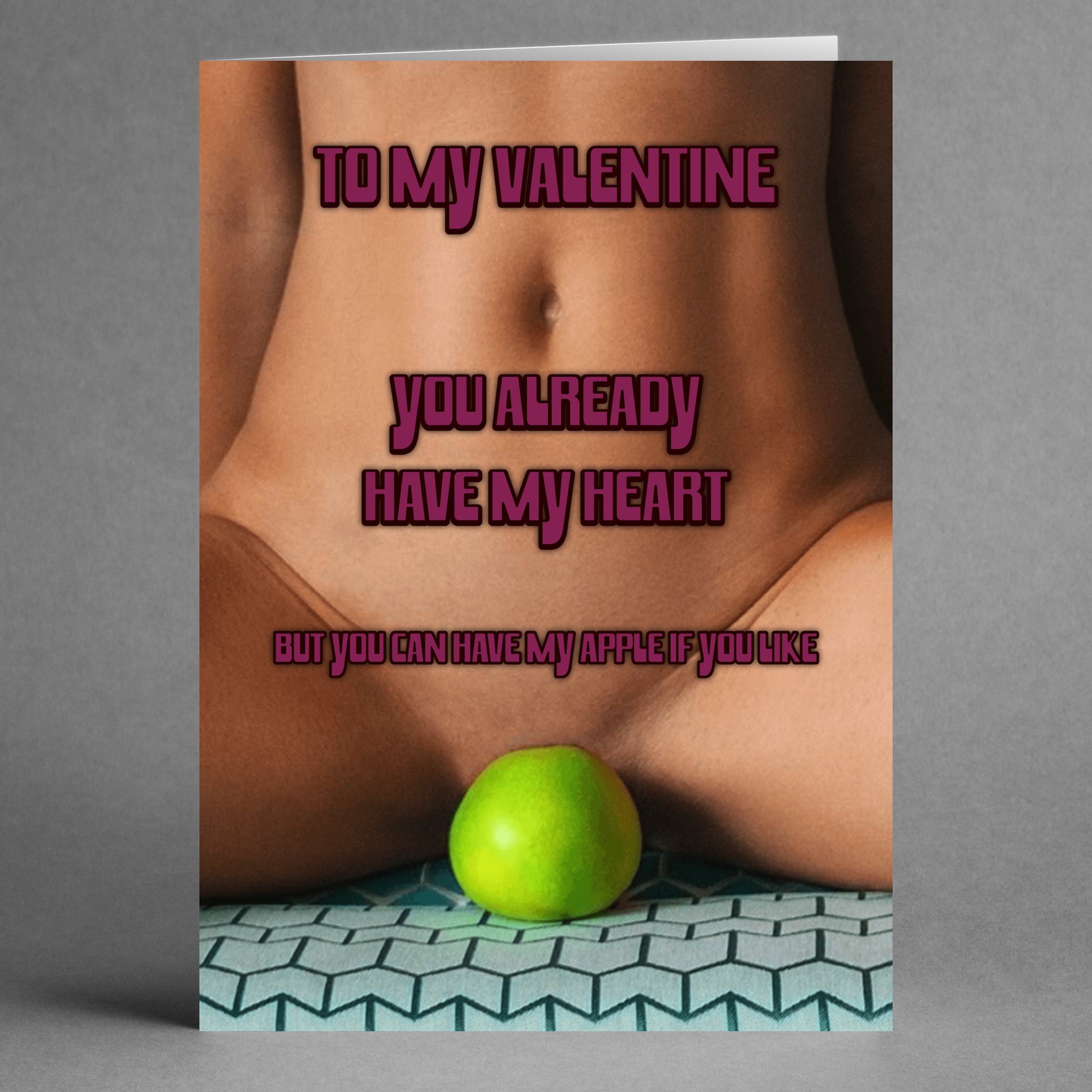 The "My Apple Rude Valentine's Card" by Twisted Gifts presents a playful message: "To my Valentine, you already have my heart, but you can have my apple if you like," accompanied by an image of someone holding a green apple. It's ideal for those who enjoy a touch of humor.