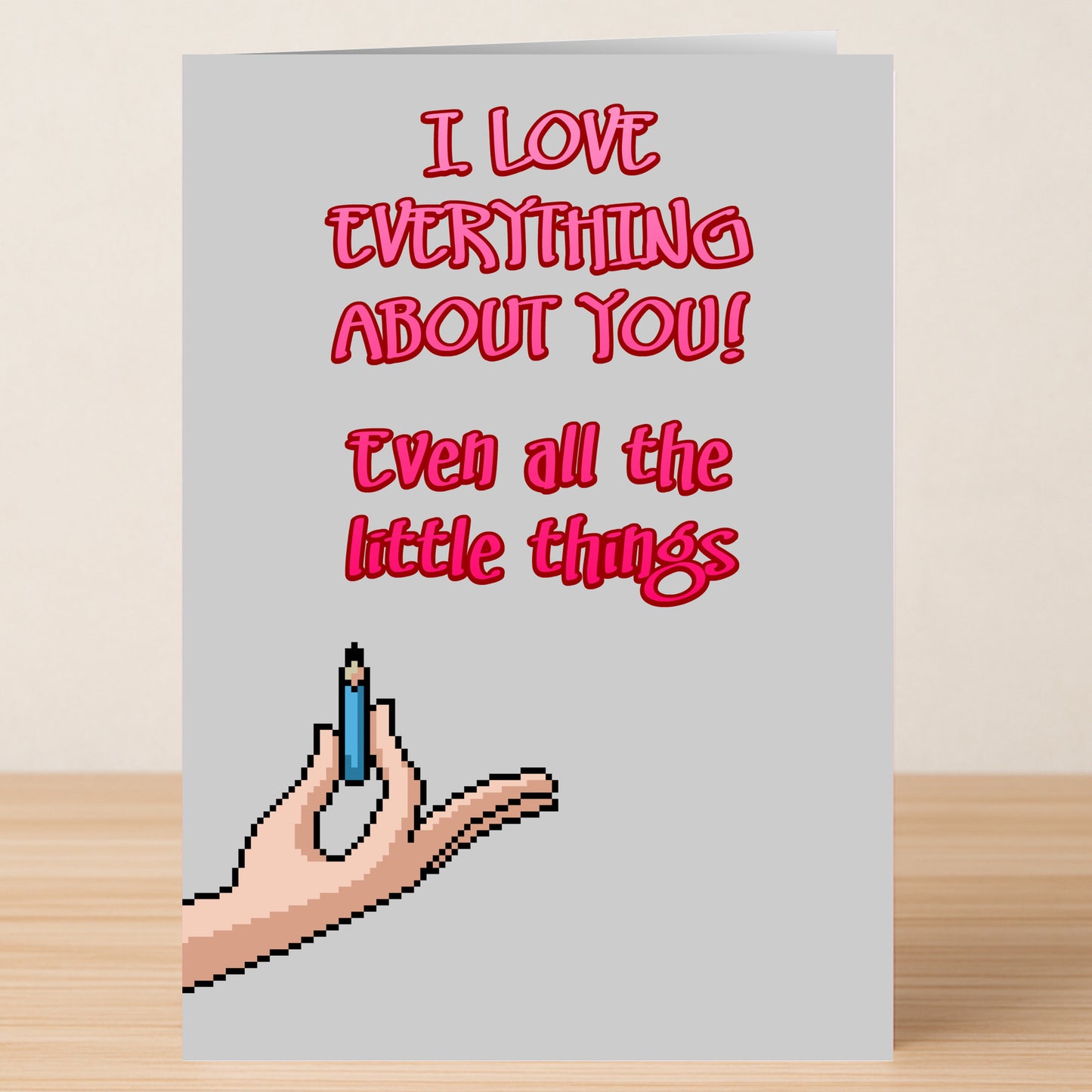 The Little Things Valentines Card by Twisted Gifts features pixel art of a hand holding a pencil and the message "I LOVE EVERYTHING ABOUT YOU! Even all the little things." A unique way to share love this Valentine's Day.