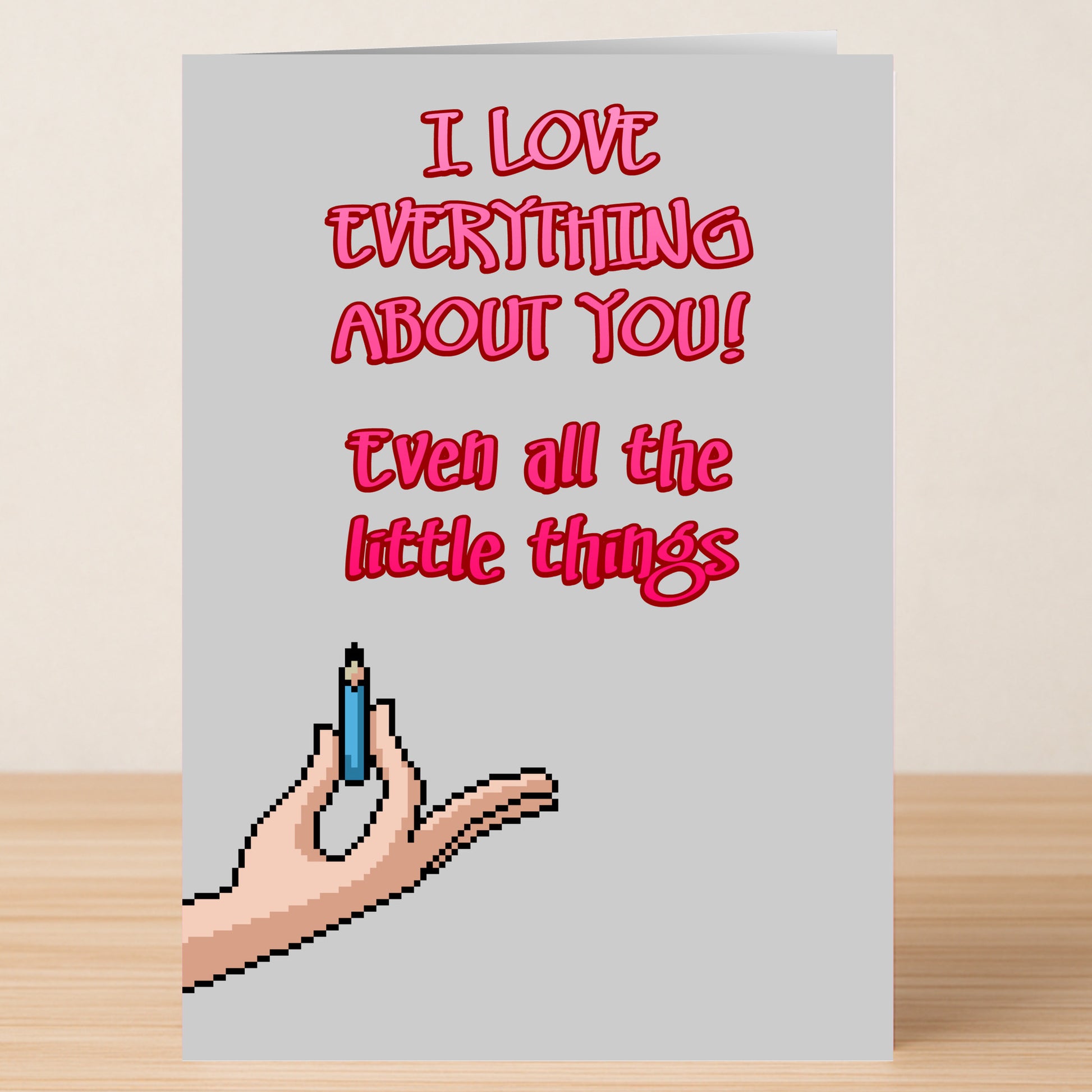 The Little Things Valentines Card by Twisted Gifts features pixel art of a hand holding a pencil and the message "I LOVE EVERYTHING ABOUT YOU! Even all the little things." A unique way to share love this Valentine's Day.