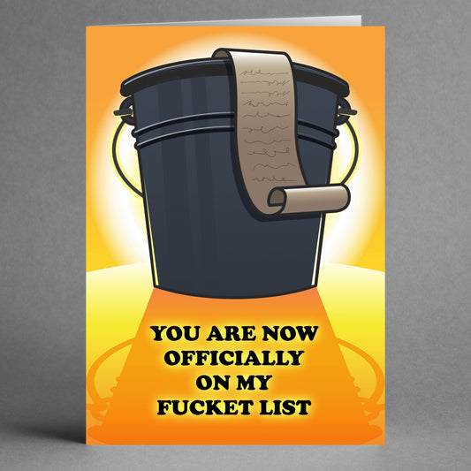 The Fuckit List Rude Valentine's Card by Twisted Gifts features a playful design with a black bucket and a scroll inside. The text humorously declares, "You are now officially on my fucket list," set against an eye-catching blend of orange and yellow, making it an ideal humorous greeting card.