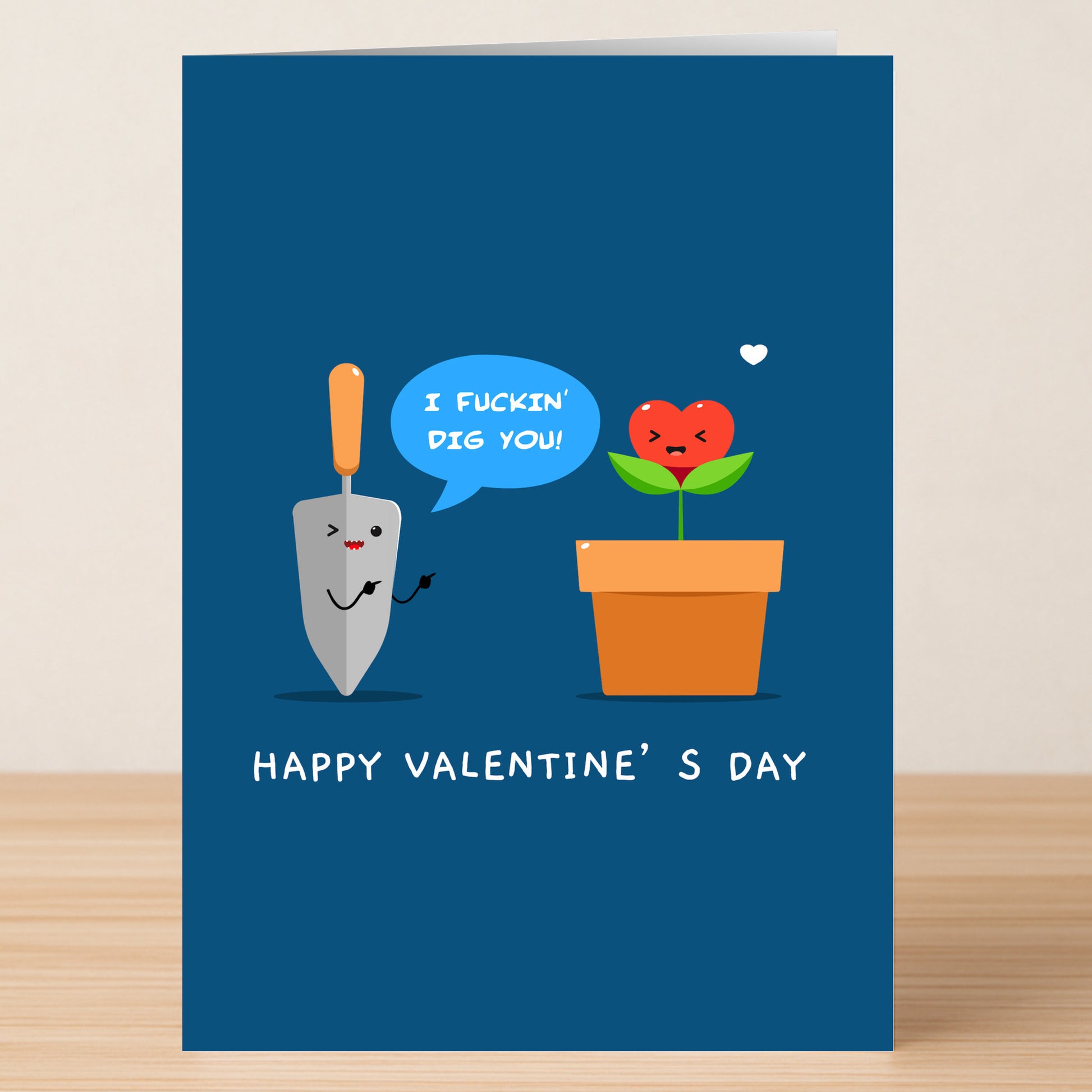 The Dig You Funny Valentine's Card by Twisted Gifts features a cartoon trowel telling a heart-shaped flower, "I fuckin' dig you!" with "HAPPY VALENTINE'S DAY" below. A perfect humorous card for someone special!.