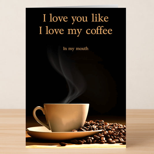 The Love My Coffee Rude Greeting Card by Twisted Gifts features a steaming coffee cup with beans and the cheeky message, "I love you like I love my coffee: In my mouth." Perfect for coffee lovers with a sense of humor.