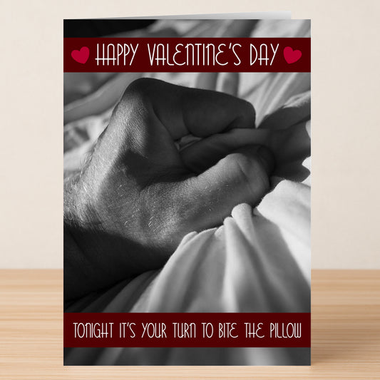 The Pillow Rude Valentine's Card by Twisted Gifts features a grayscale hand gripping a bedsheet with the cheeky message "Tonight it’s your turn to bite the pillow." A hilariously bold card for quirky Valentine’s Day wishes!.