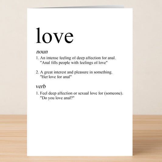 The Love Funny Valentine’s Card by Twisted Gifts features a unique white design on wood, with witty humor in a mock dictionary entry for "love" and playful example sentences.