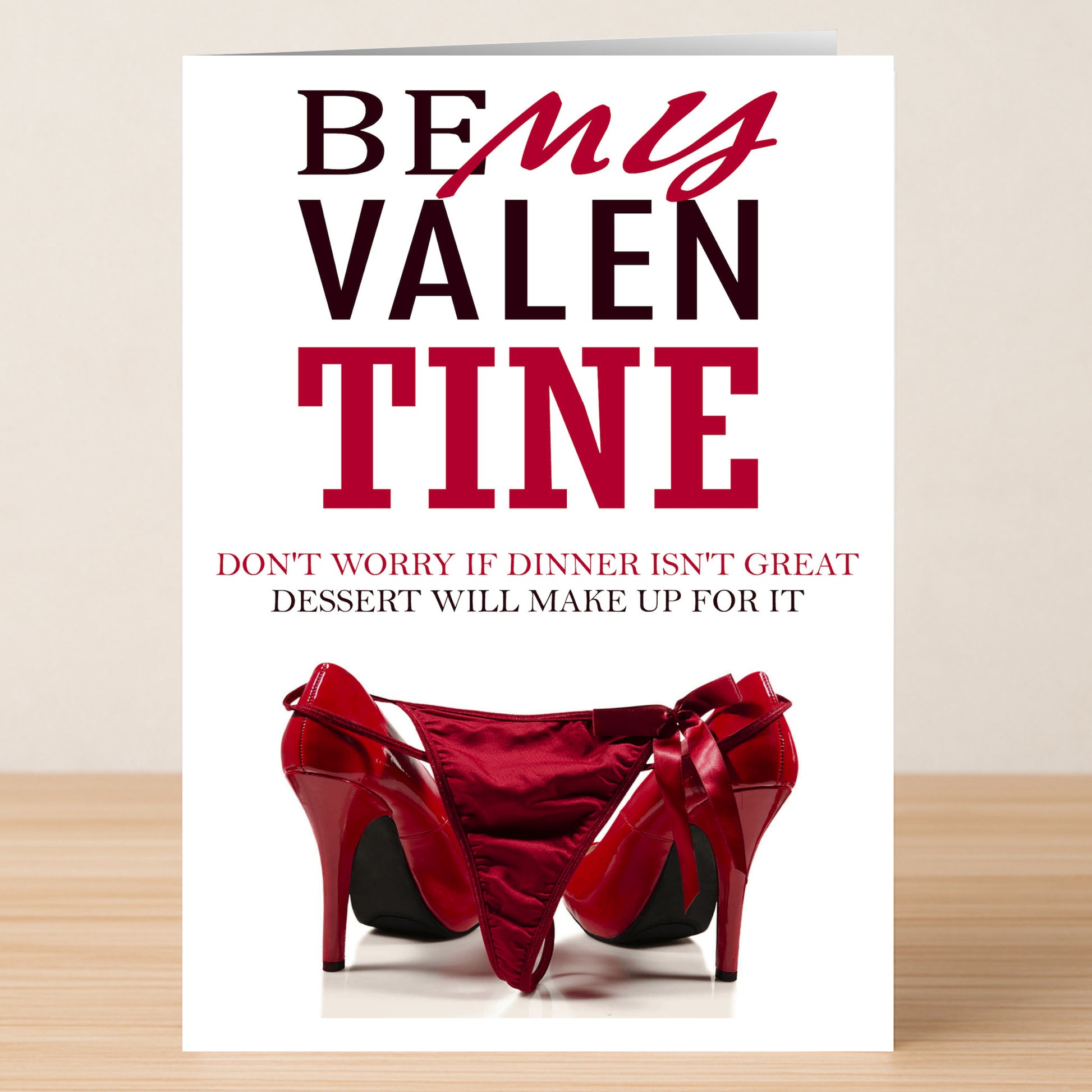 The Dessert Funny Valentine's Card by Twisted Gifts features playful red heels and lingerie with the message: "Be My Valentine. Don't worry if dinner isn't great, dessert will make up for it." Perfect for a flirty celebration!.