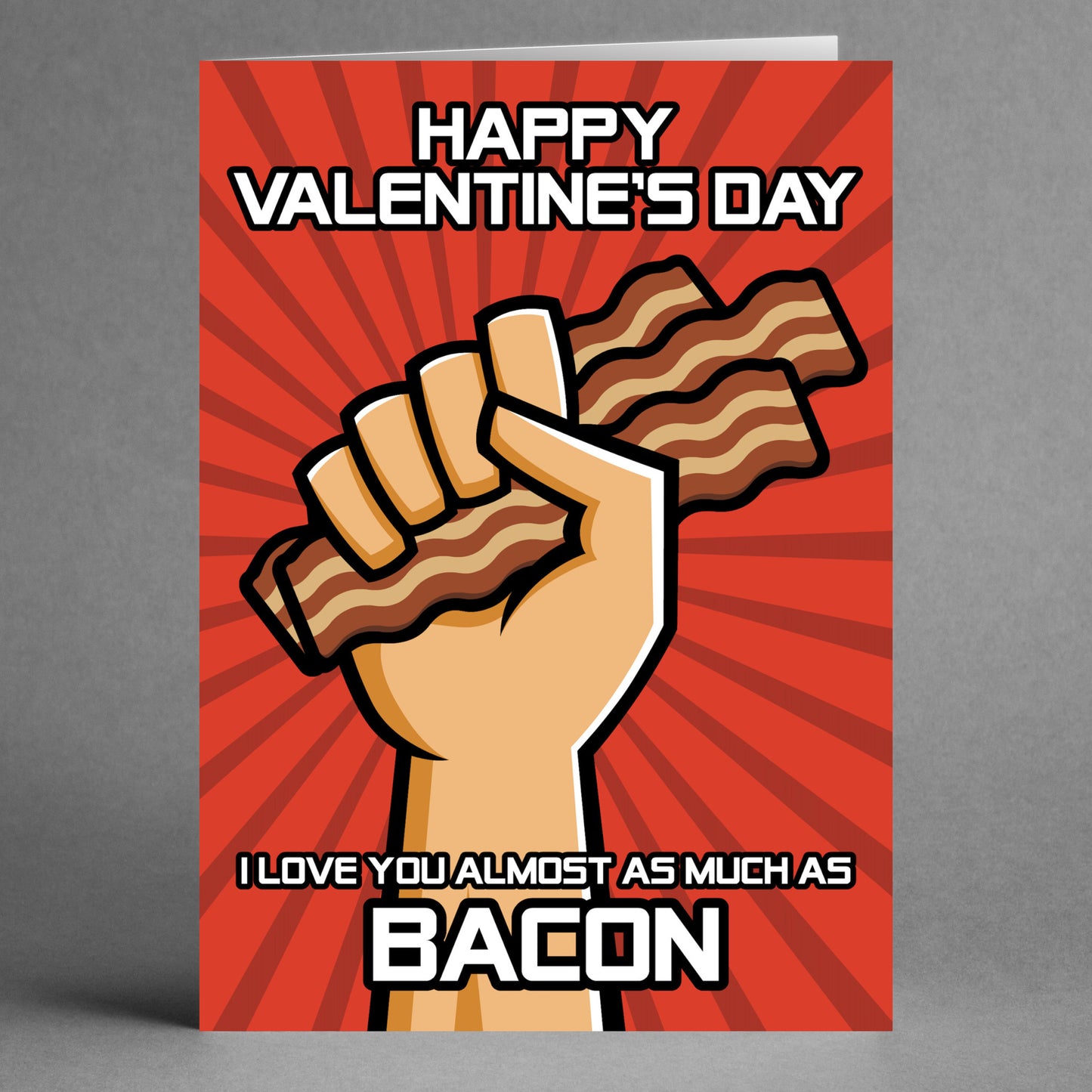 Presenting the Bacon Funny Valentine's Card by Twisted Gifts: This card showcases a hand holding bacon strips alongside the playful text, "Happy Valentine's Day. I love you almost as much as bacon." Ideal for bacon enthusiasts, this humorous greeting card is sure to bring joy to your loved one.