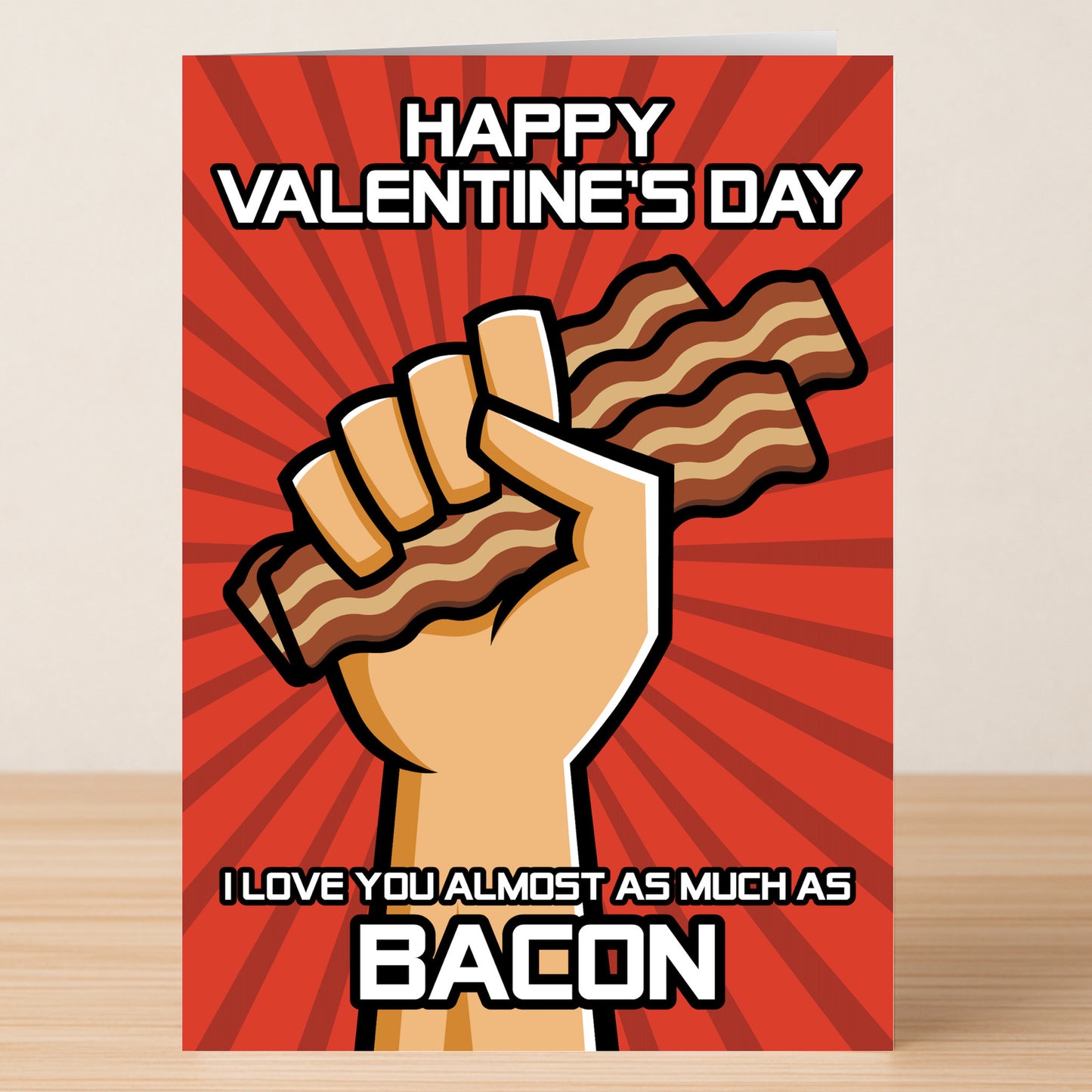 The Bacon funny Valentine's Card by Twisted Gifts features a cartoon hand holding bacon strips with the message: "Happy Valentine's Day. I love you almost as much as bacon"—an ideal, humorous card for bacon lovers.