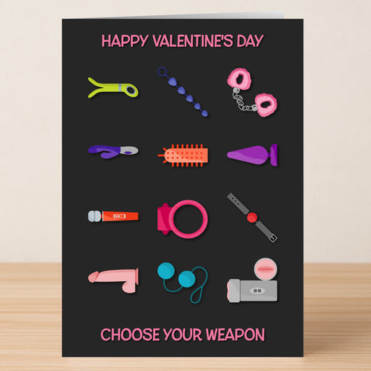 The "Choose Your Weapon Rude Valentine's Card" by Twisted Gifts features colorful adult toy illustrations and the phrases "Happy Valentine's Day" and "Choose Your Weapon" on a bold black background.