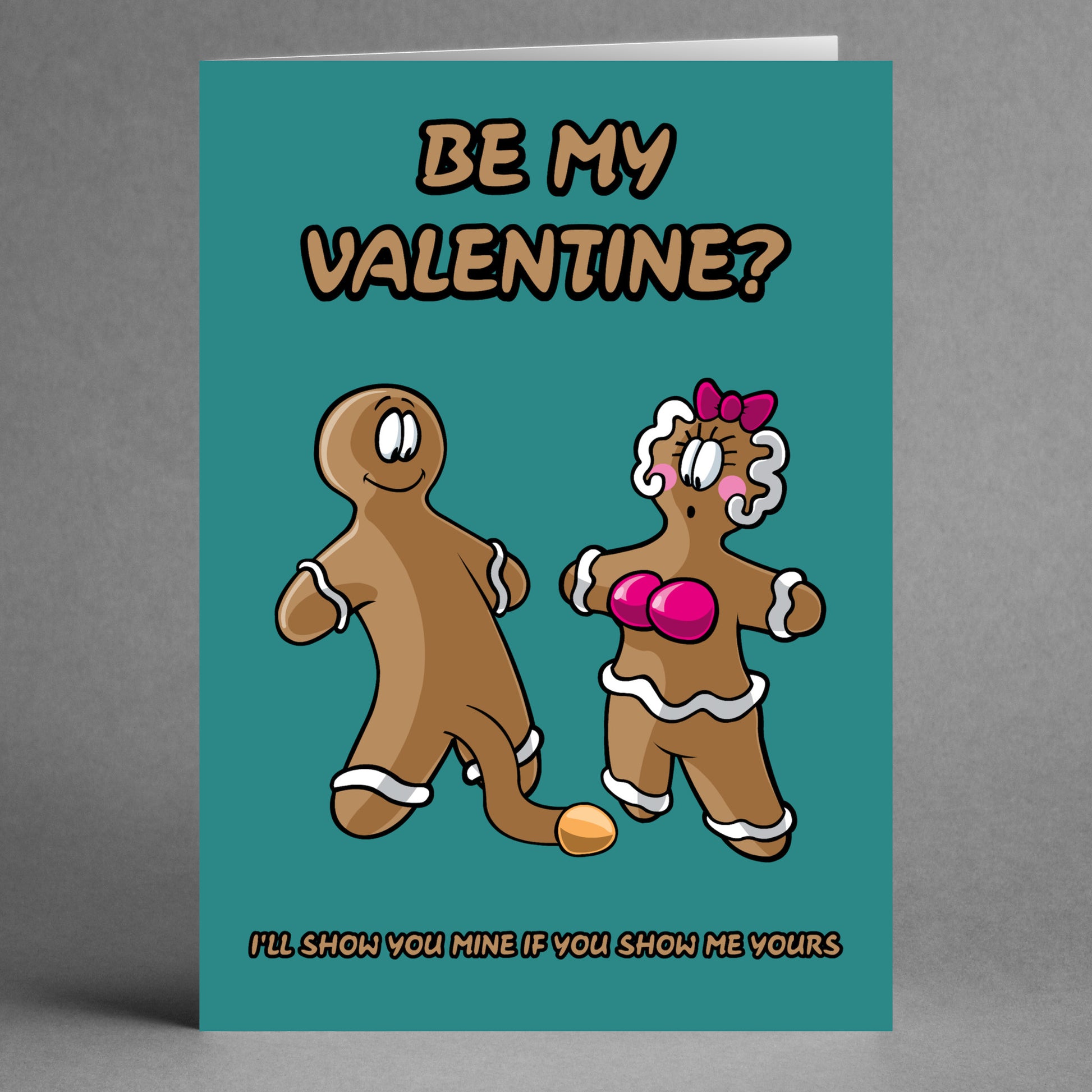 The Show Me Yours Rude Valentine's Card by Twisted Gifts humorously features cartoon gingerbread figures—one male and one female—alongside the playful text "Be My Valentine?". With a cheeky twist, the card adds at the bottom, "I'll show you mine if you show me yours.