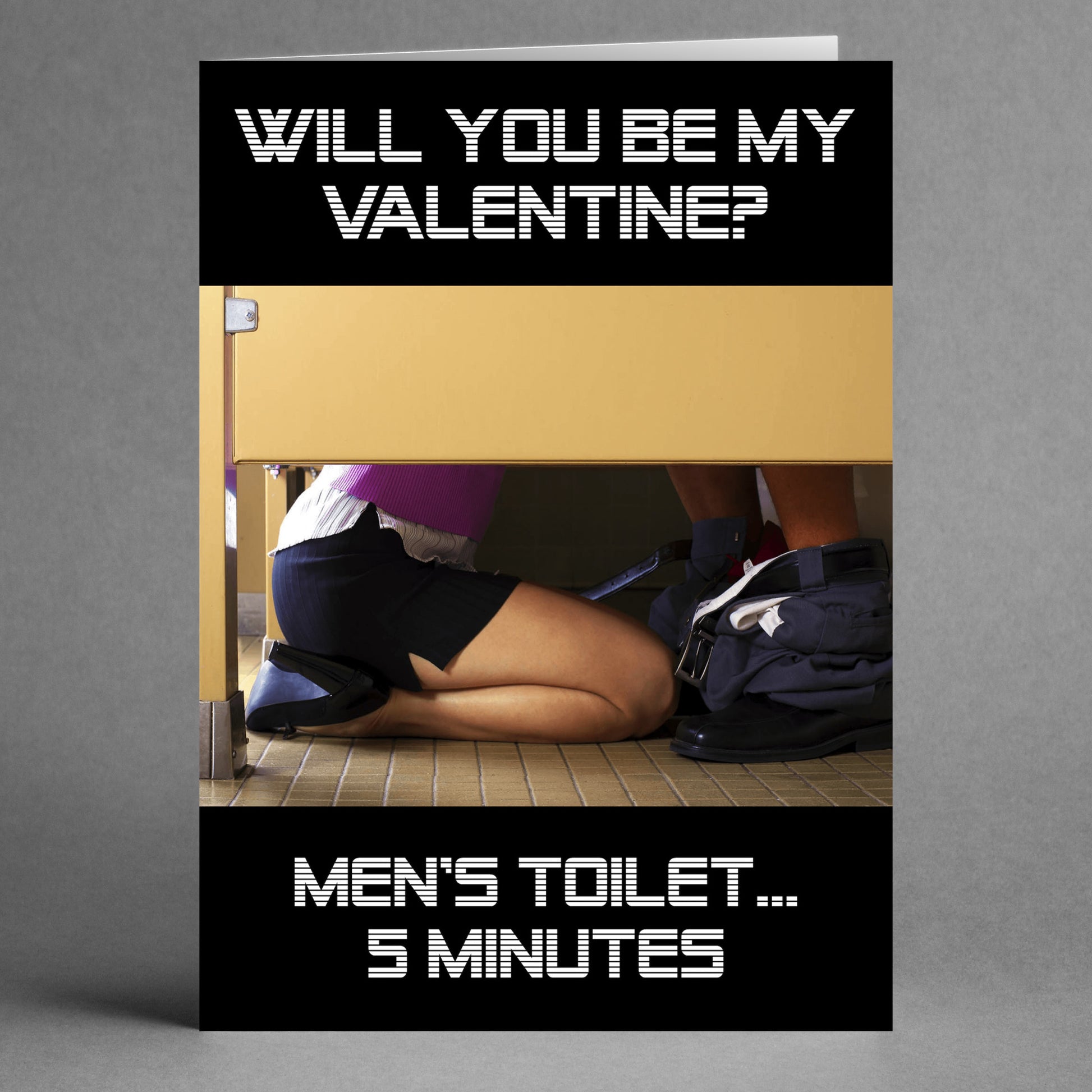 Introducing the 5 Minutes Funny Valentine's Card by Twisted Gifts, showcasing a comical scene of someone kneeling in a bathroom stall with the caption: "Will you be my Valentine? Men's toilet... 5 minutes.