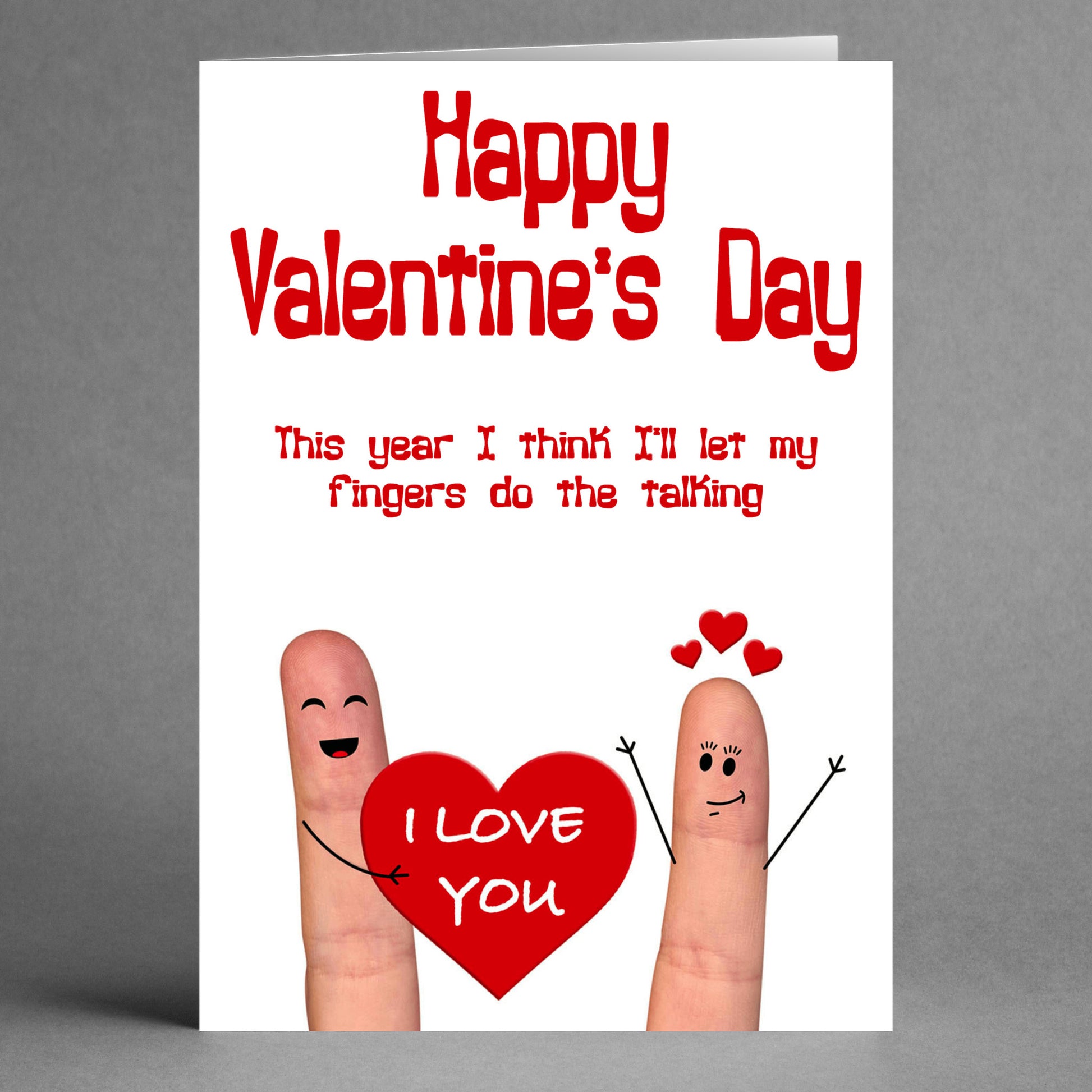 Introducing the Fingers Rude Valentine's Card by Twisted Gifts: Featuring two finger-drawn characters, one holding a heart with "I LOVE YOU," this unique card conveys a sweet sentiment infused with whimsy. The text humorously declares, "Happy Valentine’s Day. This year, I'll let my fingers do the talking.