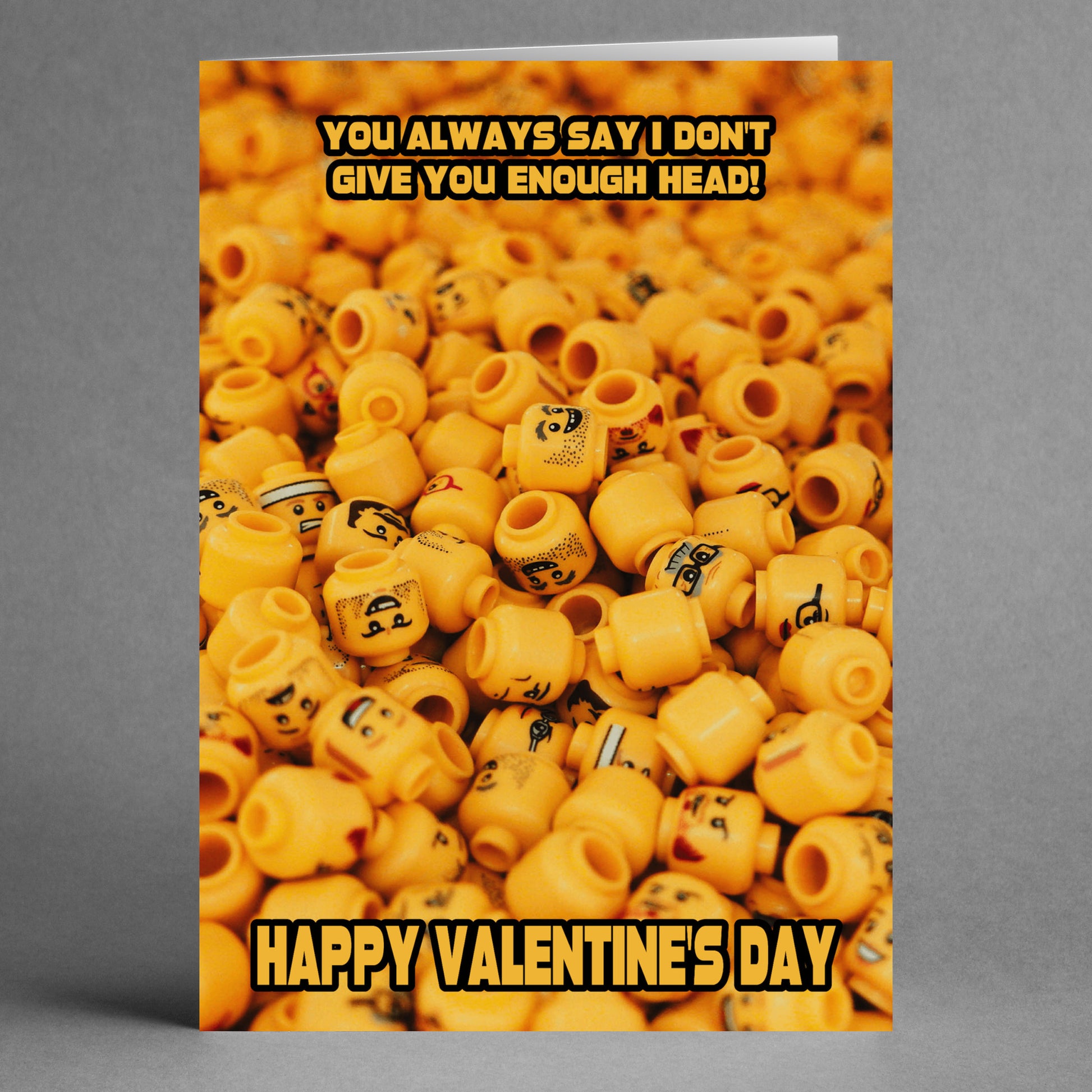 Presenting the "Not Enough Head Rude Valentine's Card" from Twisted Gifts, featuring a cheeky arrangement of LEGO heads alongside the bold message, "You always say I don't give you enough head! Happy Valentine's Day.