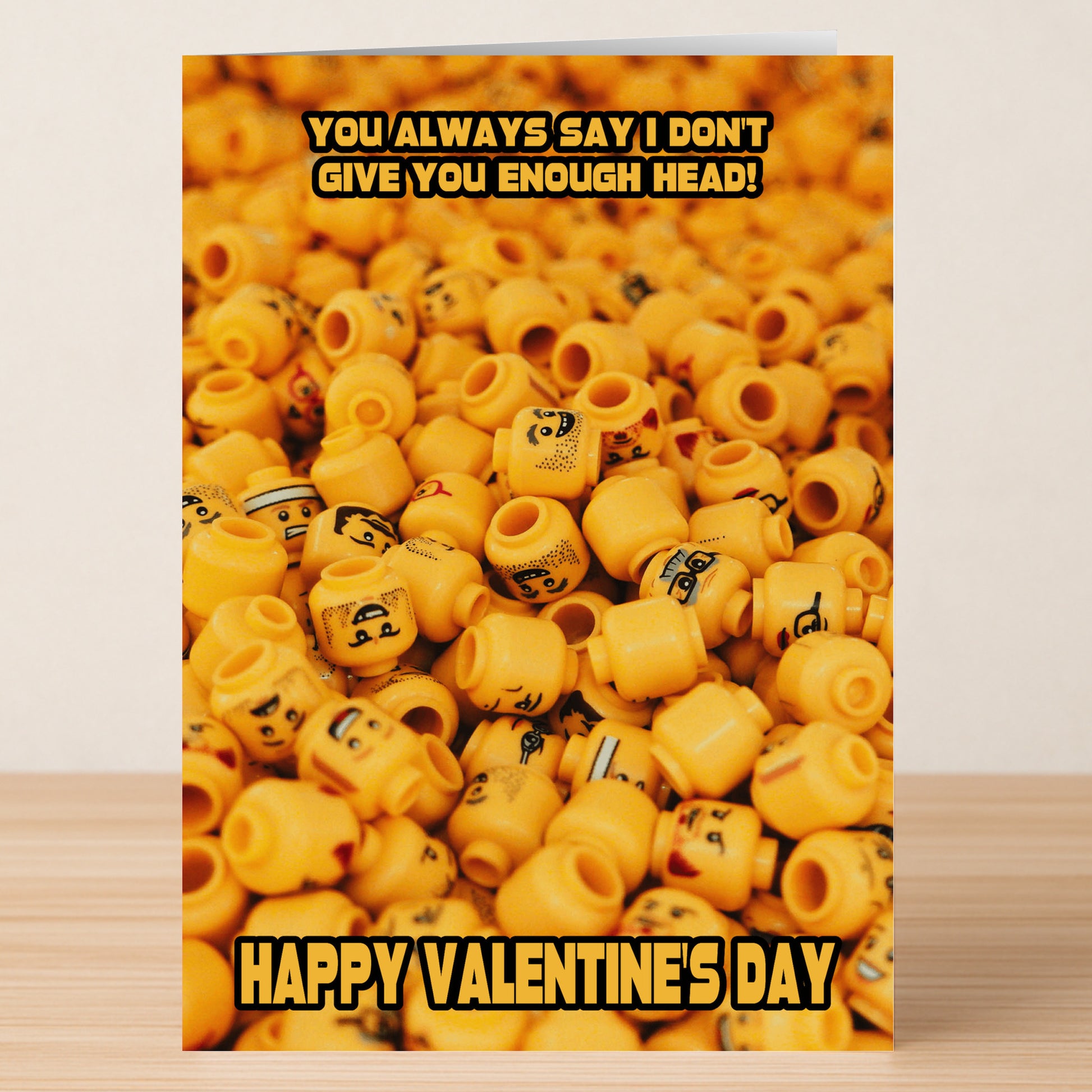The Not Enough Head Rude Valentine's Card by Twisted Gifts features a stack of LEGO minifigure heads and the bold message, "You always say I don't give you enough head! Happy Valentine's Day." Ideal for those who love cheeky humor.