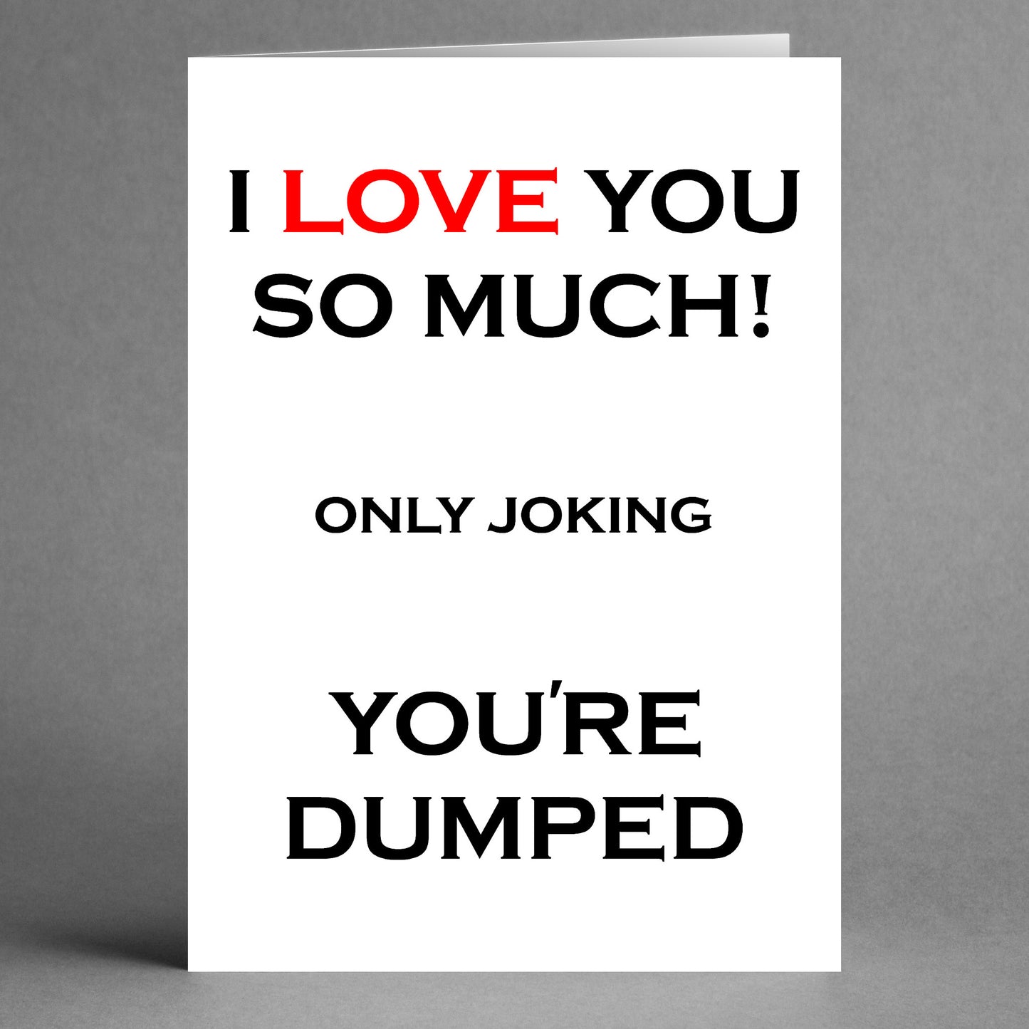 A humorous greeting card from Twisted Gifts, named the "Dumped Funny You're Dumped Card," features a witty message: "I LOVE YOU SO MUCH! ONLY JOKING YOU'RE DUMPED" on a gray background.