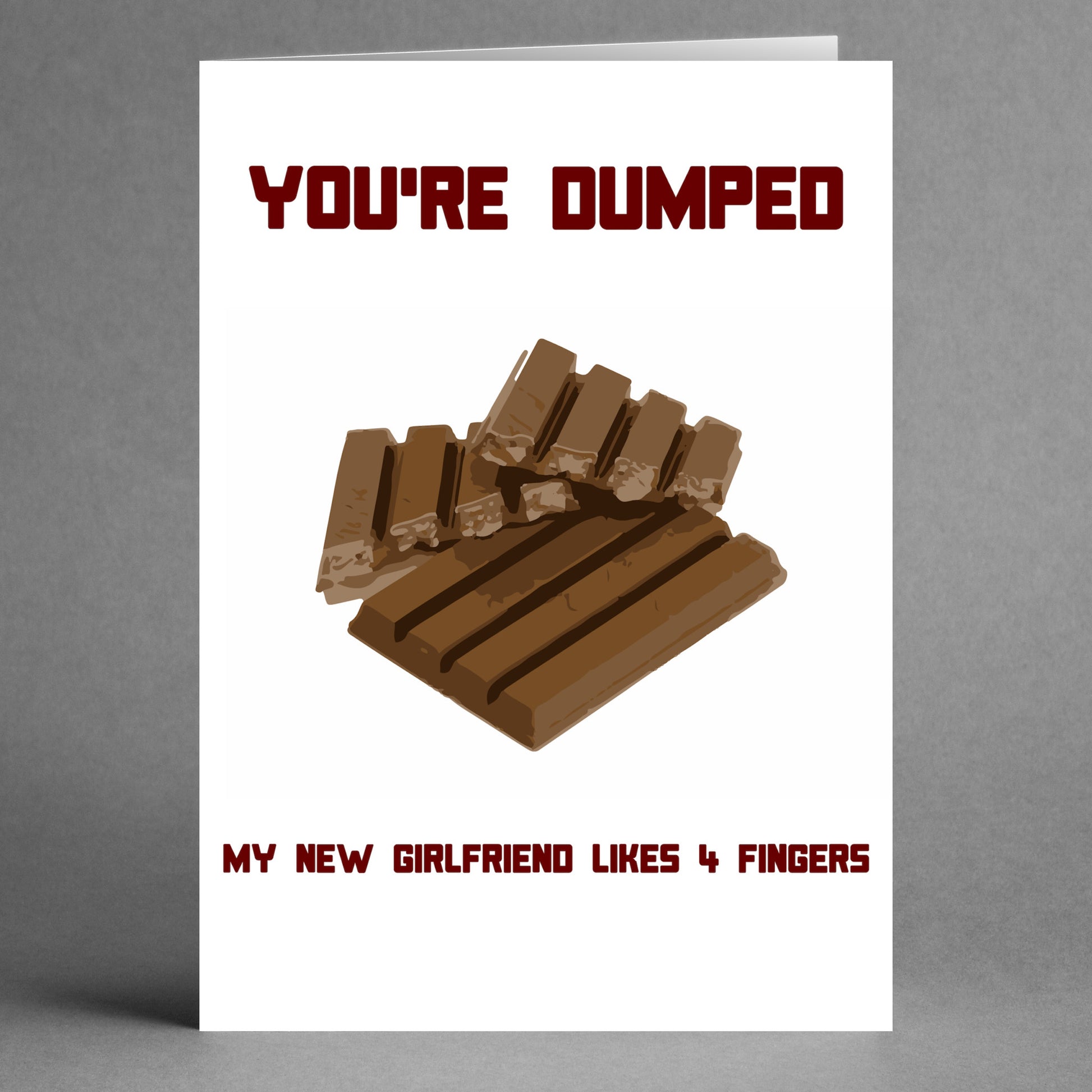 A cheeky greeting card from Twisted Gifts showcasing chocolate bars and the bold text, "You're dumped. My new girlfriend likes 4 Fingers.