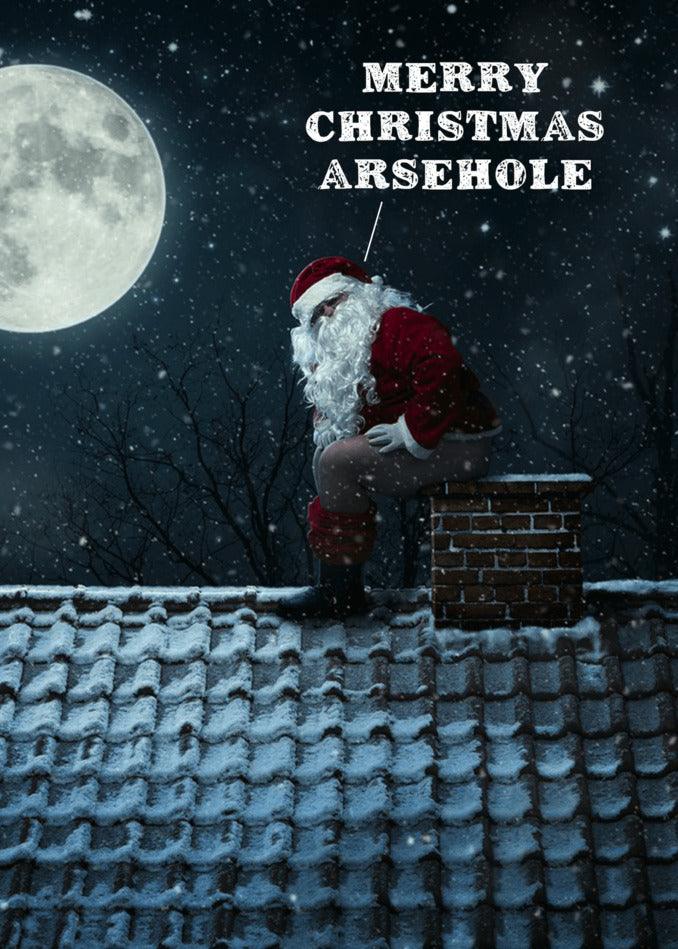Santa Claus sitting on a roof with the words "Merry Christmas Arsehole" - a hilarious twist for a Twisted Gifts Chimney Rude Christmas Card.