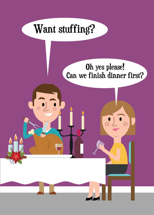 A man offers stuffing to a woman while carving a roasted turkey at a dinner table. The woman, holding a glass of wine, replies positively but suggests finishing dinner first. Candles are lit on the table, adding to the holiday cheer, making it perfect for the "Want Stuffing Rude Christmas Card" by Twisted Gifts.