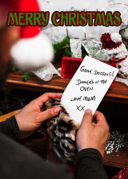 A man is holding a Twisted Gifts Gone Dogging Rude Christmas Card with a sense of humor.