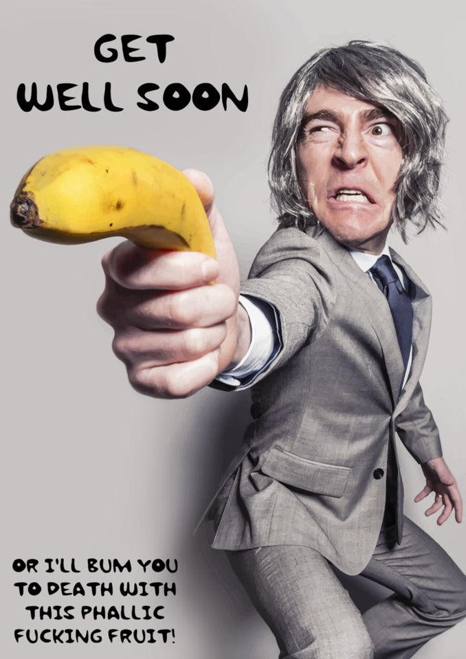 A man in a suit holding a Twisted Gifts Phallic Fruit Rude Get Well Soon Card.