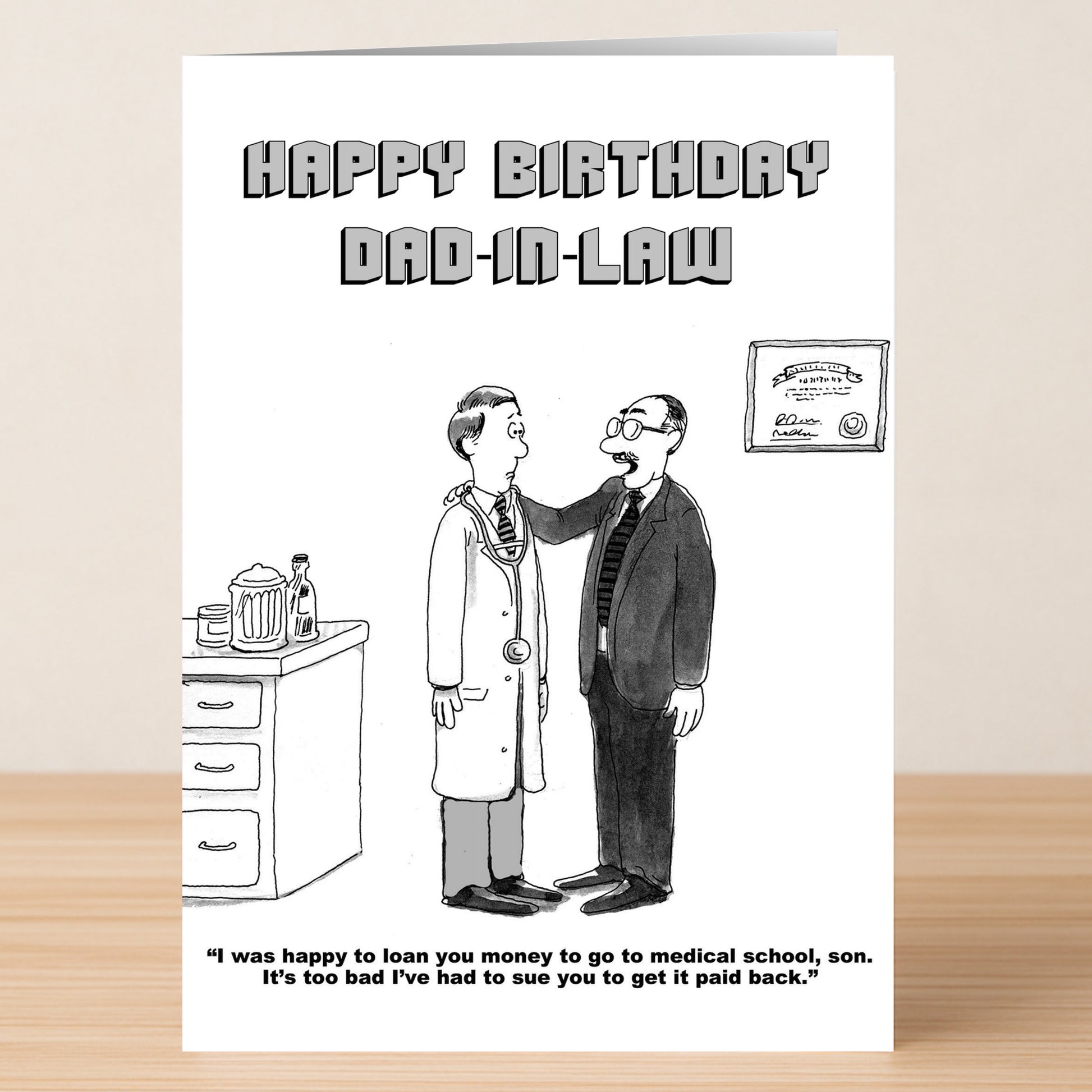 The "Sue You – Funny Birthday Card" by Twisted Gifts features a suited man talking to a doctor, joking about suing for loaned medical school money. A humorous birthday card for dads-in-law who enjoy bold, cheeky humor.