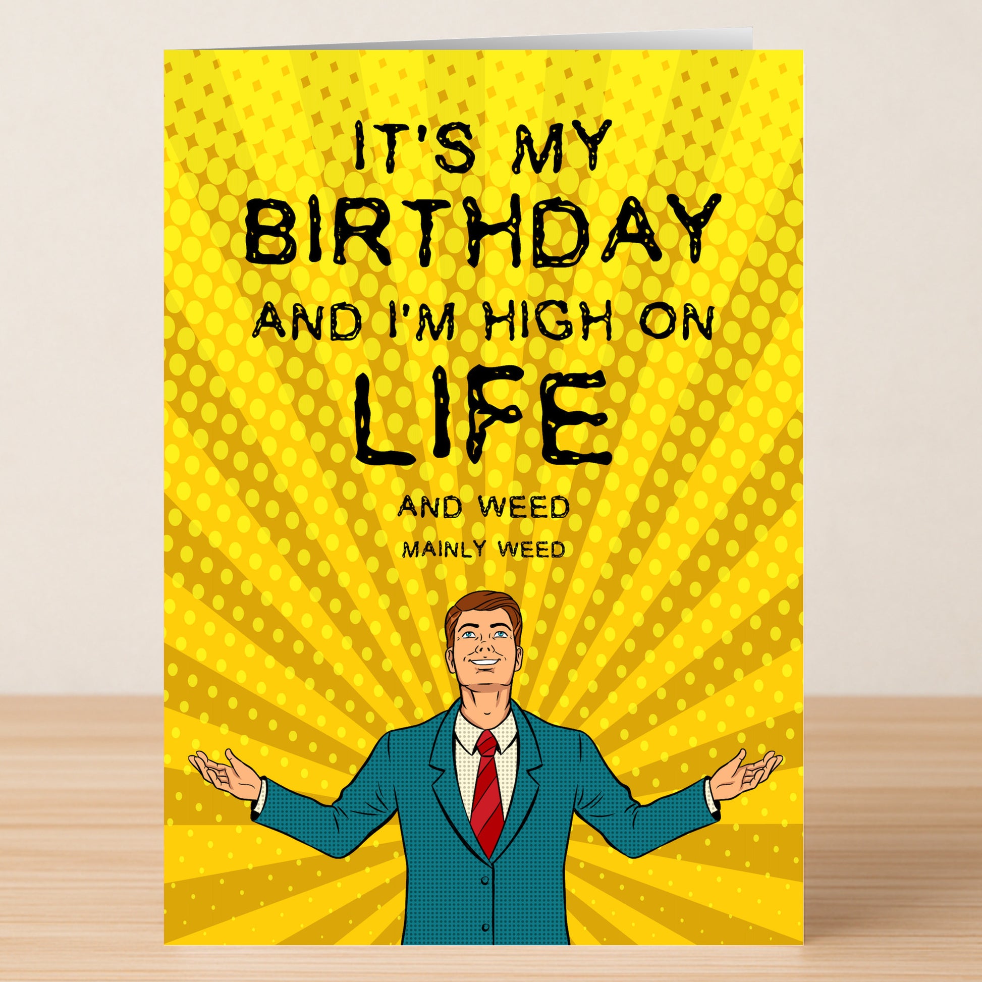 The "High On Life – Funny Birthday Card" by Twisted Gifts features a cartoon man in a suit on yellow, with the text: "IT'S MY BIRTHDAY AND I'M HIGH ON LIFE AND WEED MAINLY WEED." Perfect rude card for cheeky humor lovers.