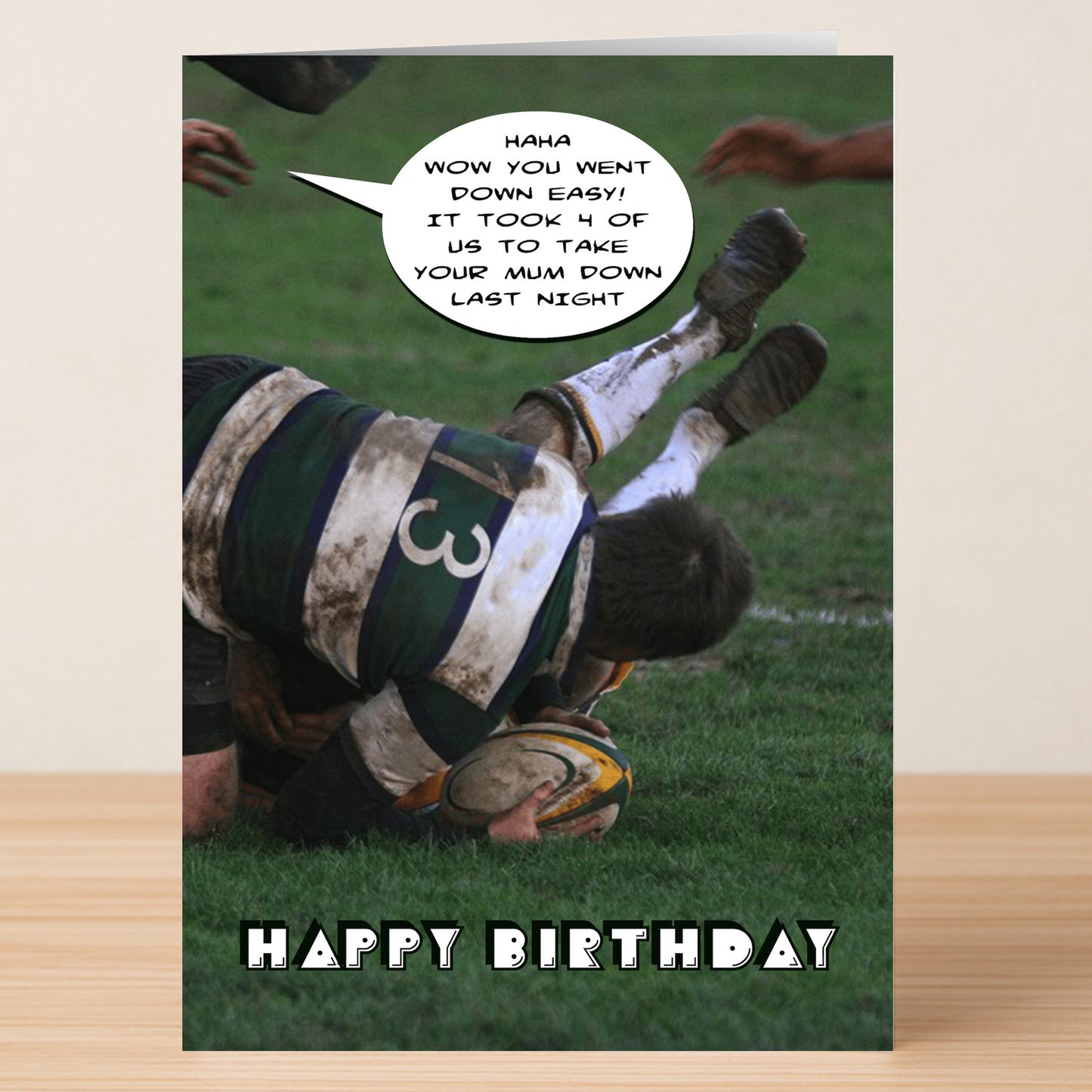 The Down Easy Rude Birthday Card by Twisted Gifts features a rugby player in a striped jersey being tackled while holding a ball, with a sassy speech bubble and "Happy Birthday" text—ideal for anyone who loves edgy humor.