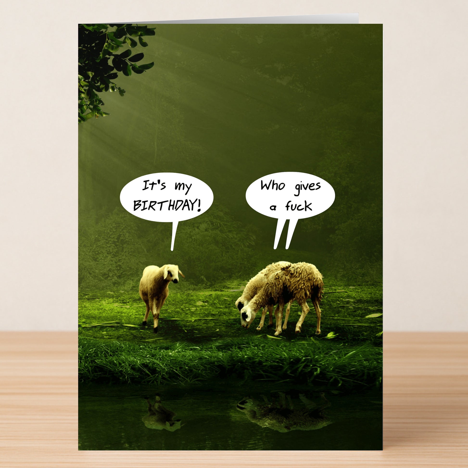Two sheep stand on grass by a pond; one says "It's my BIRTHDAY!", the other replies with rude humor—It’s My Birthday – Funny Birthday Card by Twisted Gifts, perfect for fans of offensive cards and a good laugh.