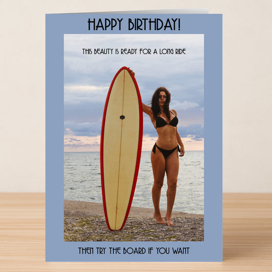 A woman in a bikini stands on the beach holding a surfboard upright, featured on Twisted Gifts' "Ready For A Ride – Rude Birthday Card" with funny text above and below.