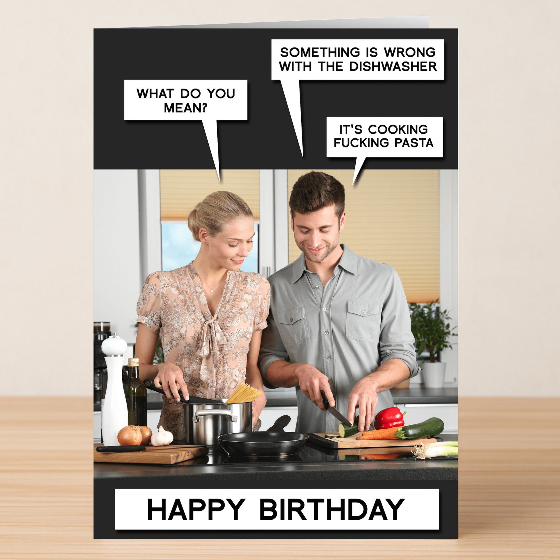 The Twisted Gifts Dishwasher Funny Birthday Card features a man and woman in the kitchen joking about the dishwasher cooking pasta. With "HAPPY BIRTHDAY" at the bottom, it's a humorous card for someone’s special day.