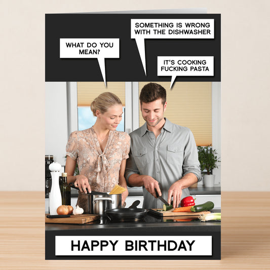 A woman and a man cook in the kitchen, joking that the dishwasher is making pasta. "HAPPY BIRTHDAY" appears below. Dishwasher – Funny Birthday Card by Twisted Gifts—perfect for anyone with a cheeky sense of humor!.