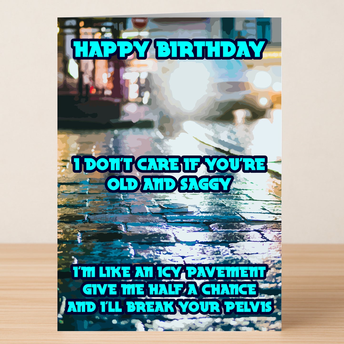 Pelvis – Rude Birthday Card by Twisted Gifts: "Happy Birthday. I don't care if you're old and saggy. I'm like an icy pavement—give me half a chance and I'll break your pelvis." Features wet cobblestones background.