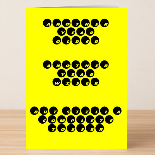 Twisted Gifts’ Tosser – Insulting Birthday Card features bold black text on a yellow background: "Another year older, another year wiser, but still a complete tosser." A hilarious, cheeky birthday card for anyone who loves rude humor.
