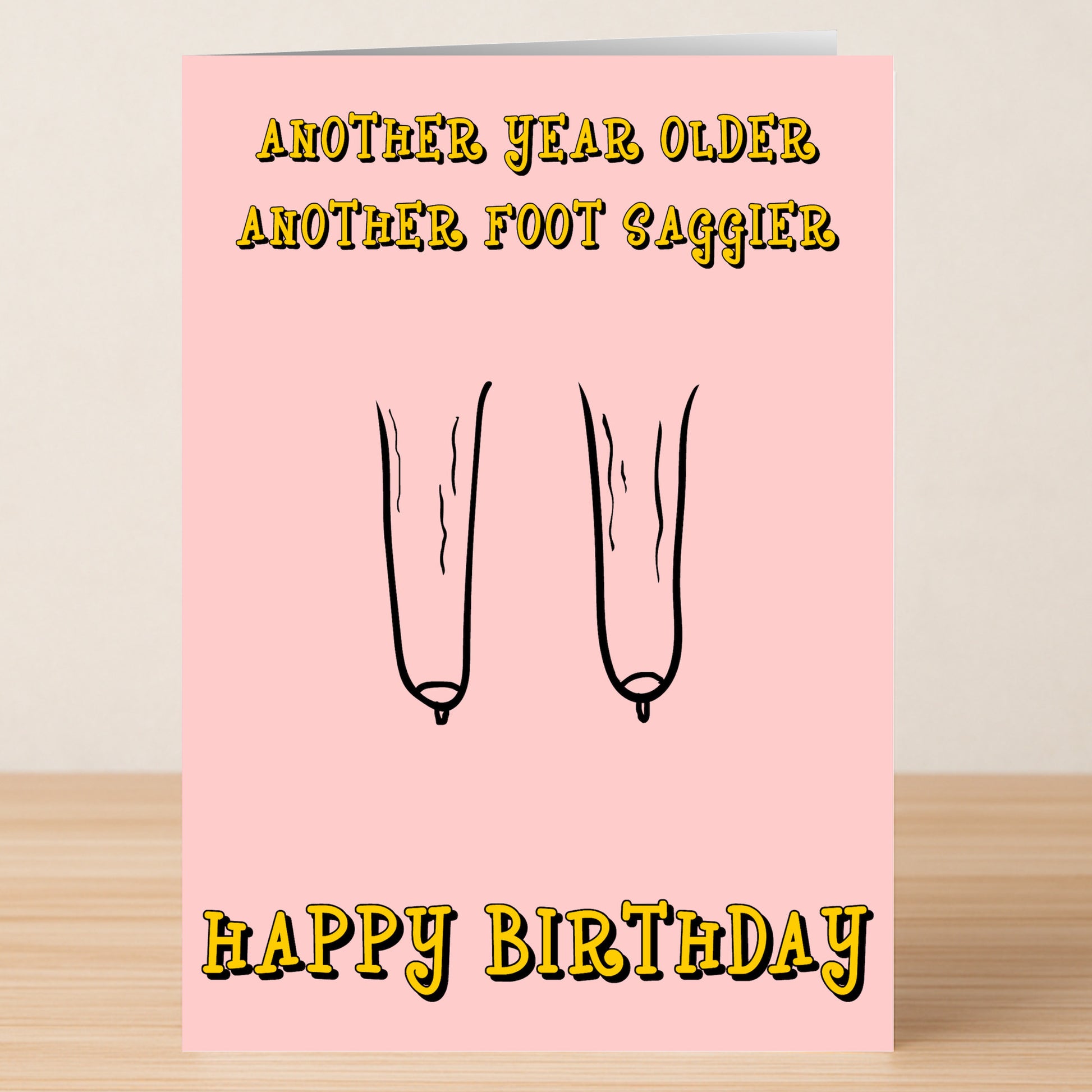 The "Another Foot Saggier – Insulting Birthday Card" by Twisted Gifts features two drooping balloons and the message, "Another year older, another foot saggier. Happy Birthday." Perfect for fans of cheeky humor.
