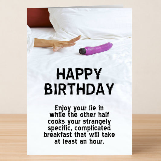 A hand reaches for a purple vibrator on a bed above the text: "HAPPY BIRTHDAY. Enjoy your lie in while the other half cooks your strangely specific, complicated breakfast." Twisted Gifts' Lie In – Rude Birthday Card is perfect for anyone with a wicked sense of humor.