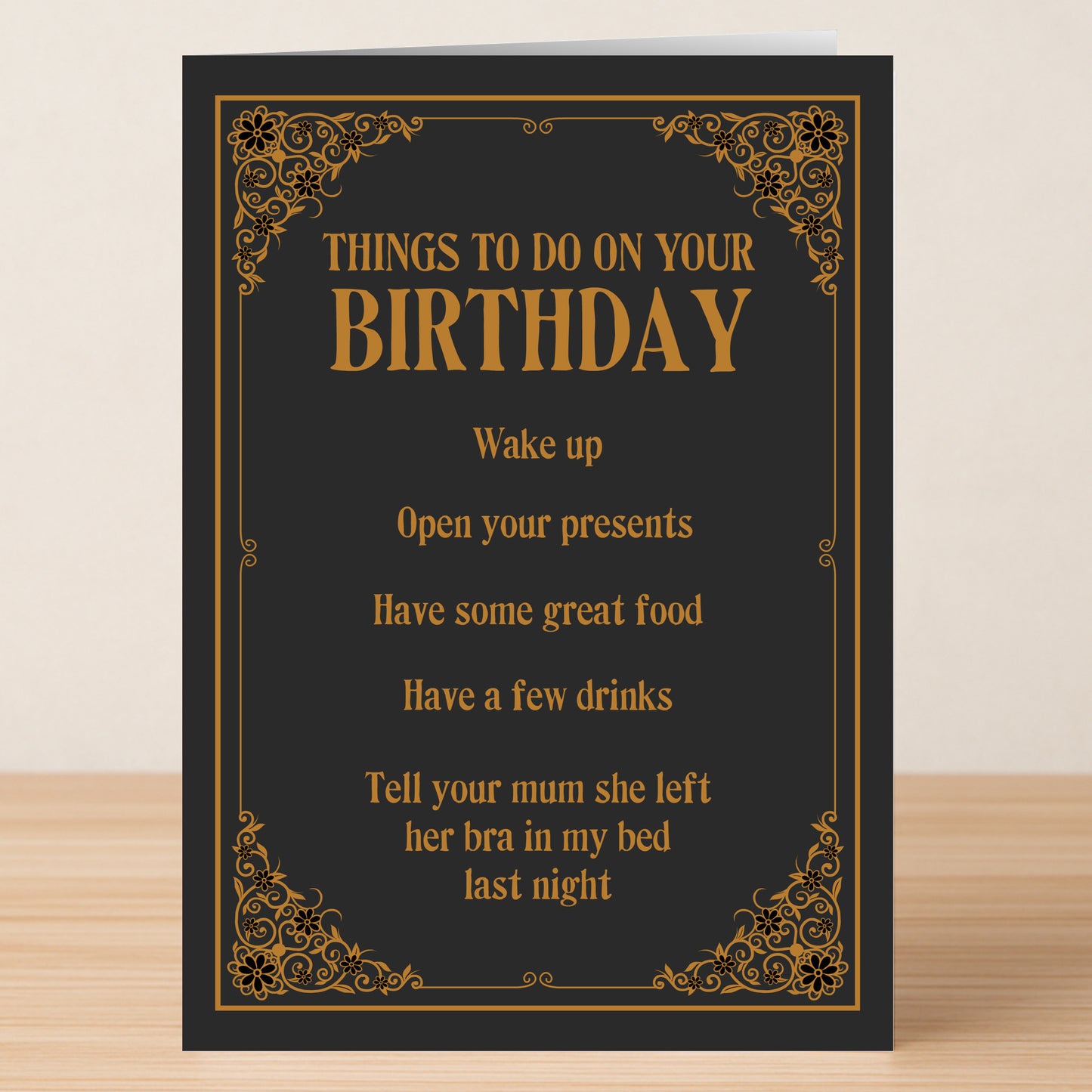 The "Tell Your Mum – Rude Birthday Card" by Twisted Gifts features a black and gold design with funny tasks like waking up, eating, drinking, opening presents, plus a cheeky joke about someone's mum leaving her bra in the bed.