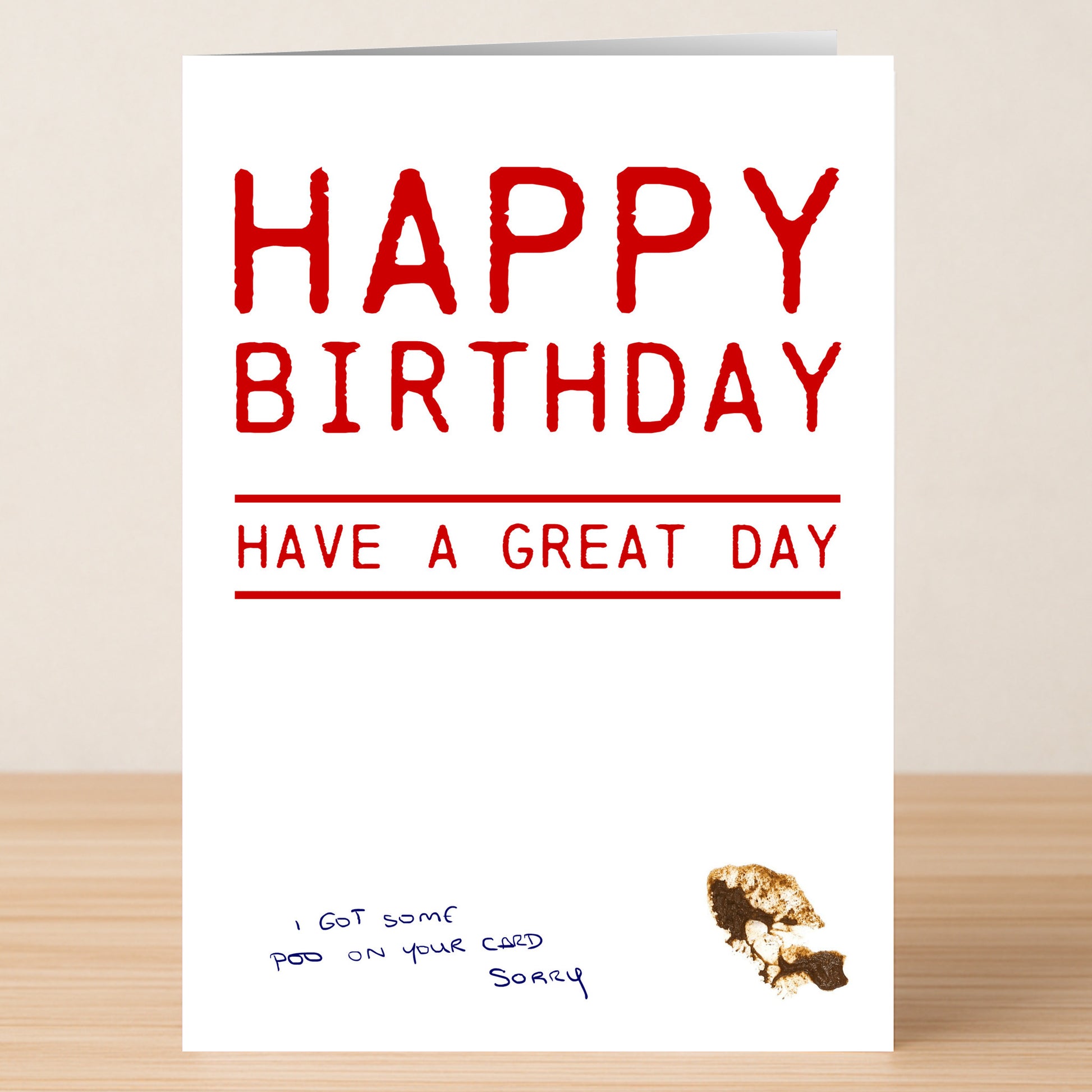 The "Poo Sorry – Funny Birthday Card" by Twisted Gifts features "HAPPY BIRTHDAY HAVE A GREAT DAY" in red, a brown smudge, and the handwritten note "I got some poo on your card sorry." Ideal for lovers of rude, humorous cards.