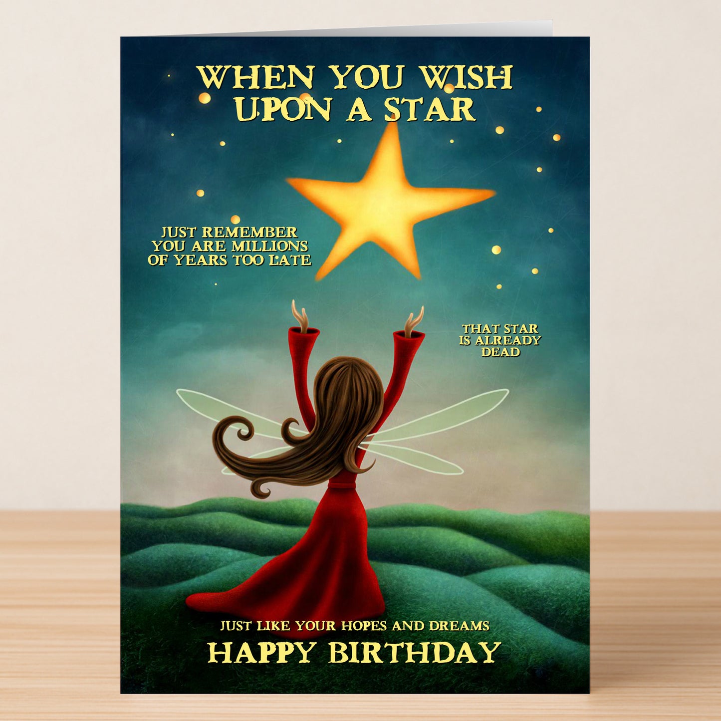 The Hopes And Dreams – Funny Birthday Card by Twisted Gifts features a fairy in a red dress reaching for a star, with humorous text about wishing on stars and dreams, ending with "Happy Birthday.